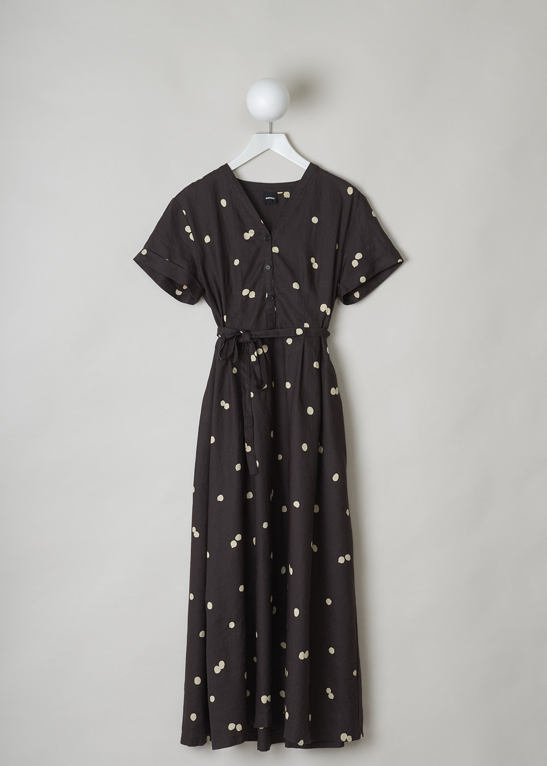 ASPESI, BROWN LINEN MAXI DRESS WITH DOTTED PRINT, 2958_M277_62331, Brown, Print, Front, This chocolate brown linen dress has a off-white dotted print throughout. The dress has a modest V-neckline and w three-button closure in the front. The dress has short sleeves with rolled cuffs. An attached belt can be used to cinch in the waist. A concealed side zip functions as the closure option. Slanted pockets re concealed in the side seam. The dress has a straight hemline.
