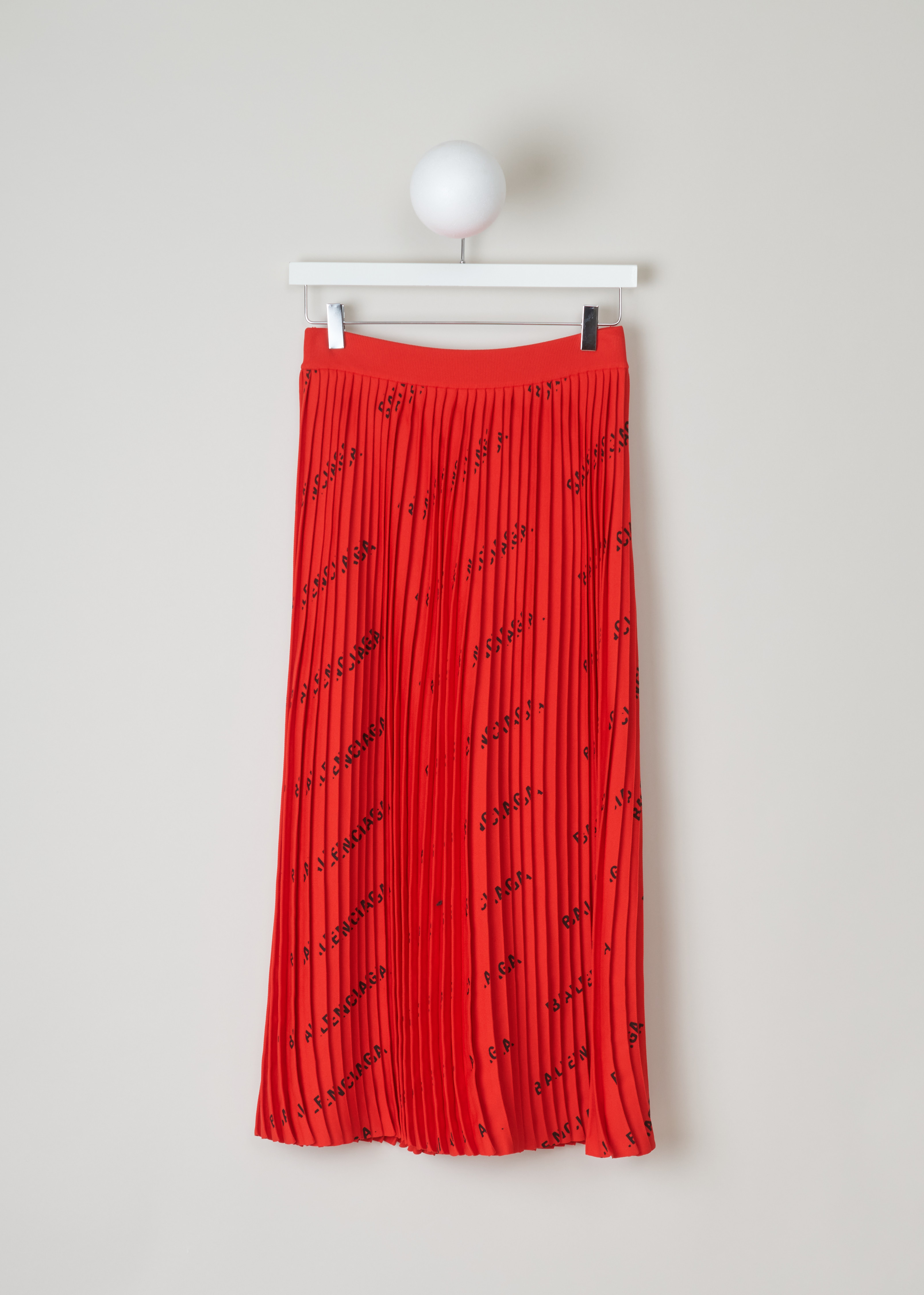 Balenciaga PlissÃ© skirt with logo pattern 570845_T6140_6282 red front. Midi length plissÃ© skirt with an all over logo print of the Balenciaga logo and an elasticated waistband.