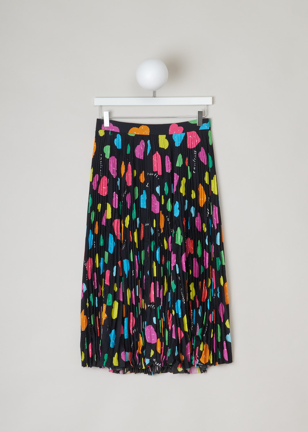 Balenciaga, Black multi-color heart print skirt, 659067_TKL09_1000_black, black, red, yellow, orange, blue, green, front. Heart-printed skirt, the black background color makes the multi-colored hearts pop that much more, this model is pleated all-around from the waistband down. Closure options on this skirt are two metal hook supported by a concealed zipper. 