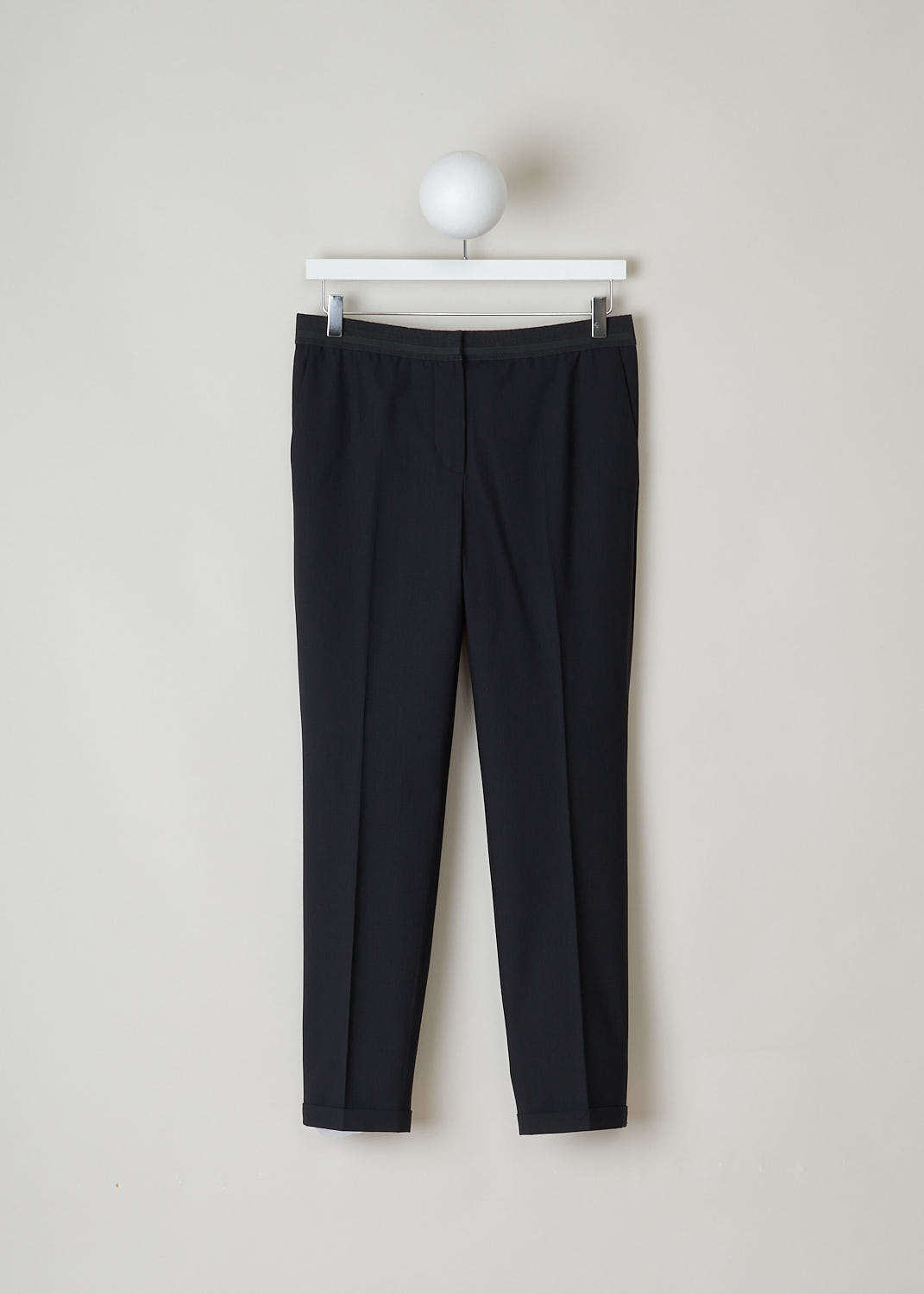 BRUNELLO CUCINELLI, BLACK PANTS WITH PARTLY ELASTICATED WAISTBAND, M0W07P1500_C101_M, Black, Front, Black pants with partly elasticated waistline. A clasp and zipper function as the closing option. The pants feature forward slanted pockets in the front, and two buttoned welt pockets in the back. Along the length of the pant leg, centre creases can be found. These pants have a folded hem.
