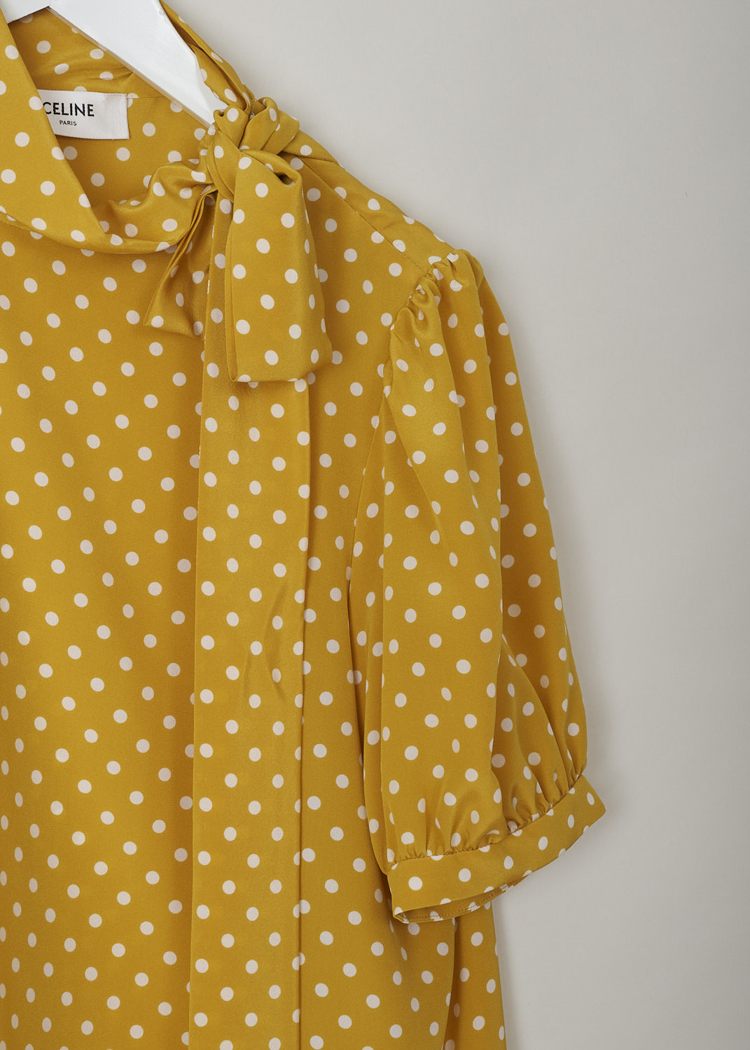 CELINE, MUSTARD YELLOW POLKA DOT TOP WITH PUSSY BOW, 966H_2B606_11TC, Yellow, Print, Detail, This mustard yellow top has a white polka dot print. The top has a high neck with a pussy bow to one side. The top has short puff sleeves. The closure option is a concealed zipper on the left shoulder.   
