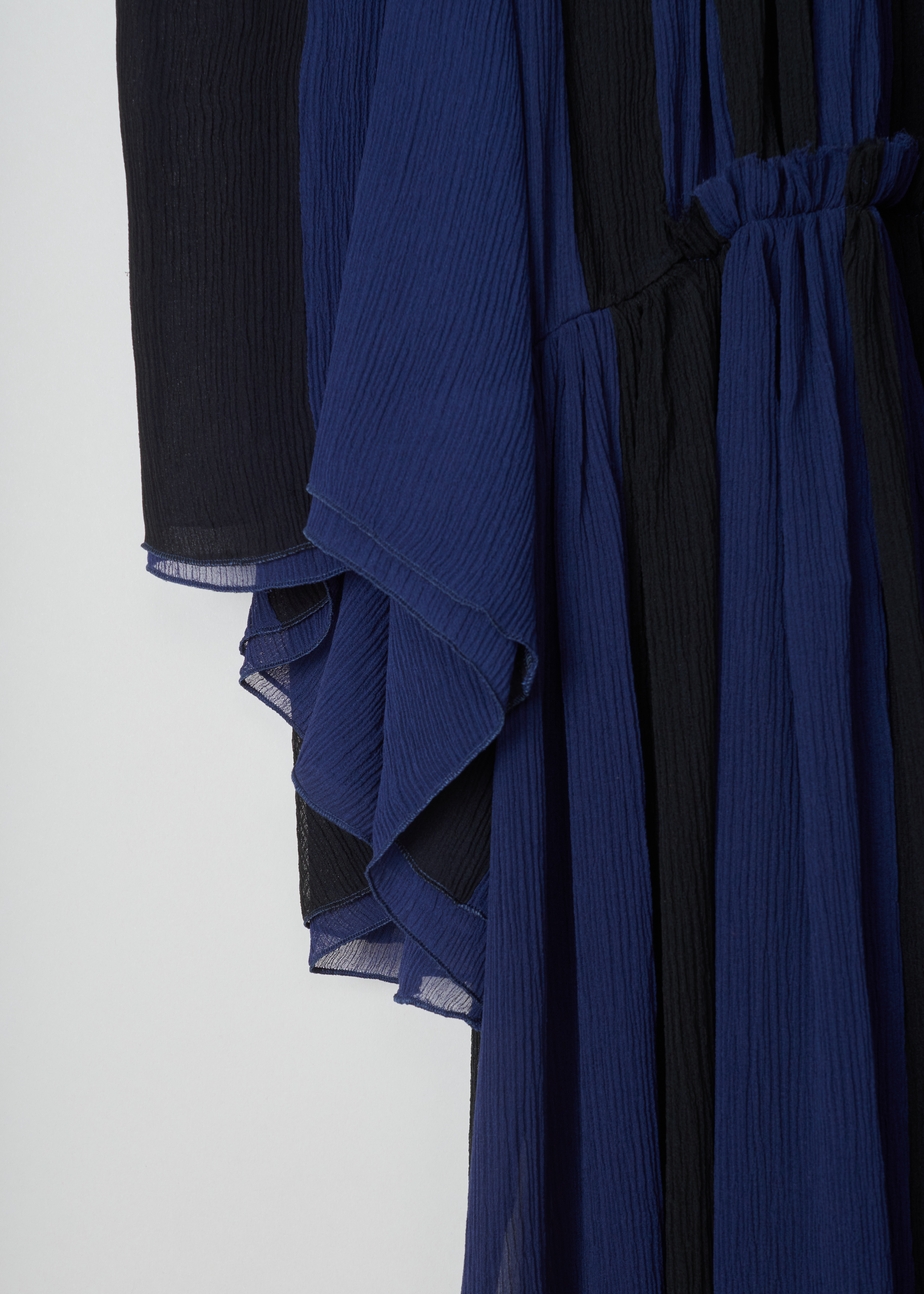 ChloÃ© Gathered slik crepe dress CHC19ARO37006925_925_Black_Blue detail. This chic silk crepe dress has a blue and black vertically striped pattern. A gathered round neckline and ruffled sheer long sleeves. A ruffled waist and flared gathered midi skirt. 