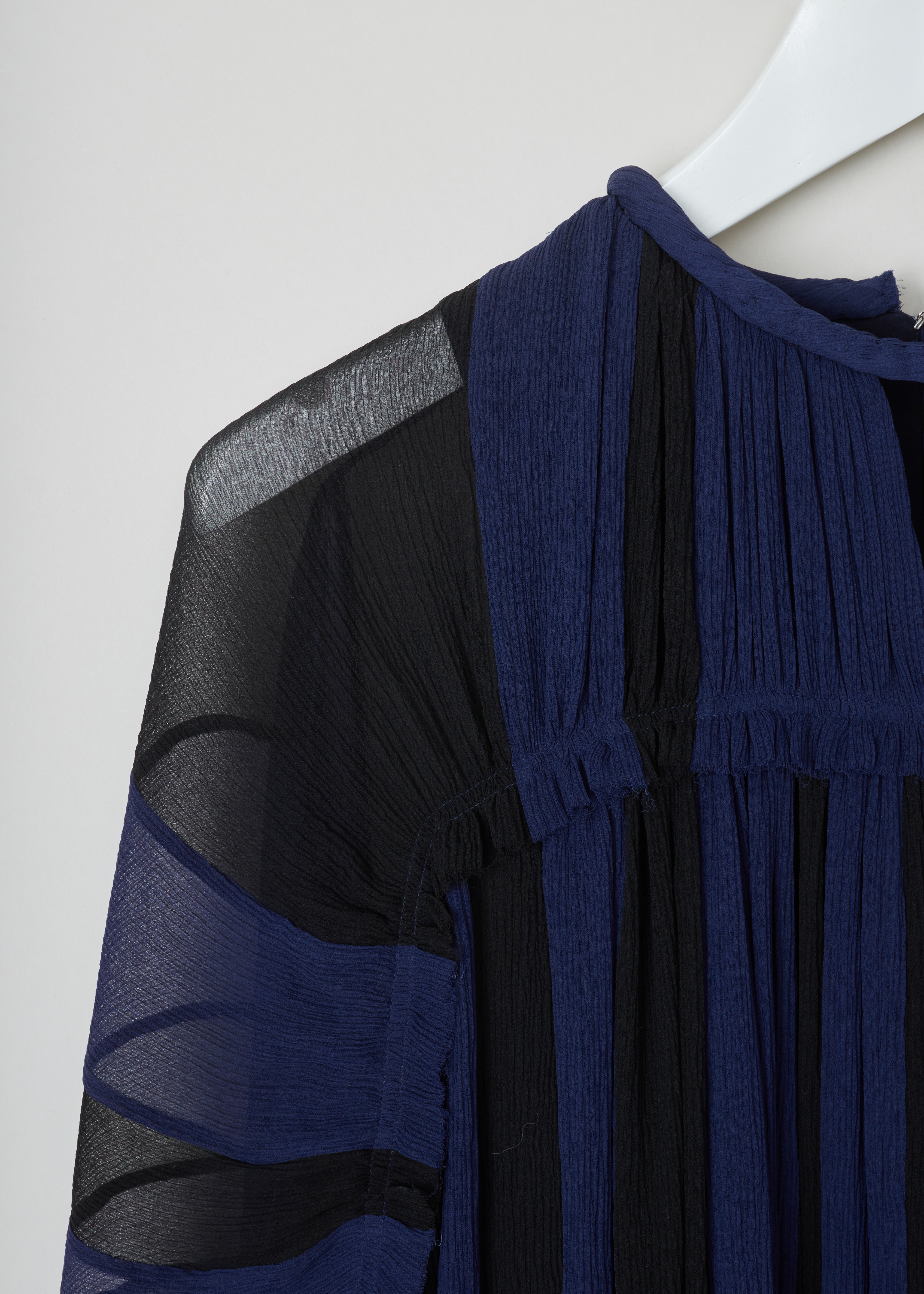 Chloé Gathered slik crepe dress CHC19ARO37006925_925_Black_Blue detail. This chic silk crepe dress has a blue and black vertically striped pattern. A gathered round neckline and ruffled sheer long sleeves. A ruffled waist and flared gathered midi skirt. 
