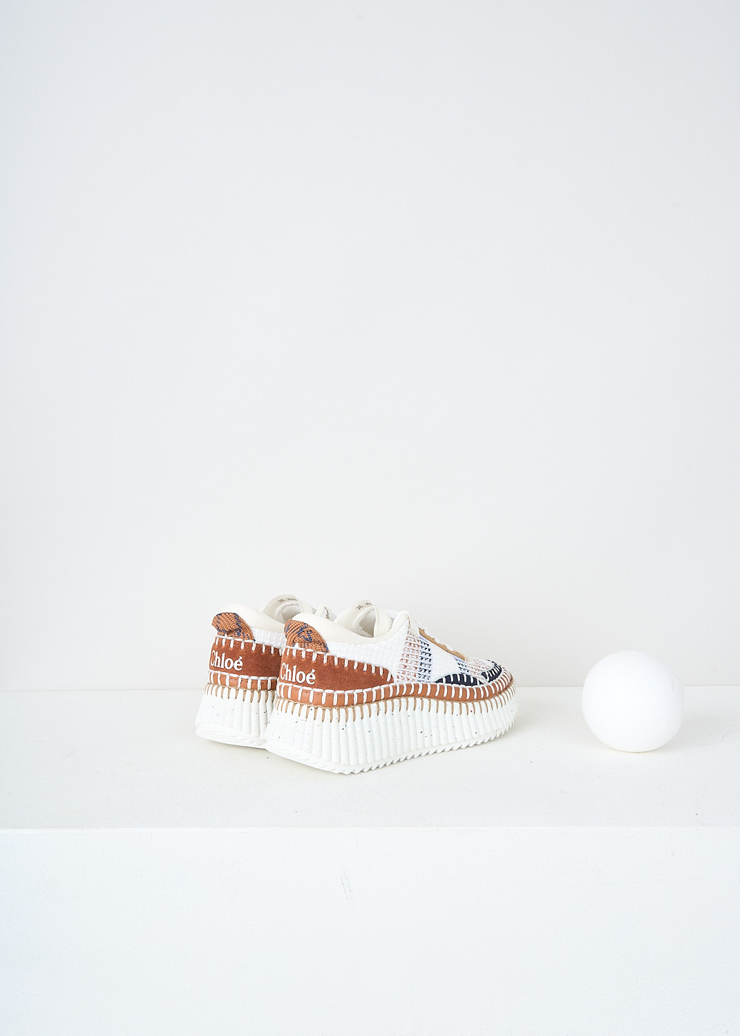 Chloé, Ginger Red Nama sneakers, 
CHC22S579Y0_646_GINGER_RED, White, Brown, Back, These eco-friendly low top Ginger Red Nama sneakers have a front lace-up fastening with white laces. These sneakers have a brown, black and white color palette with hand-stitched detailing throughout and a brown suede heel patch. The sneakers have chunky ridged white speckled soles.

