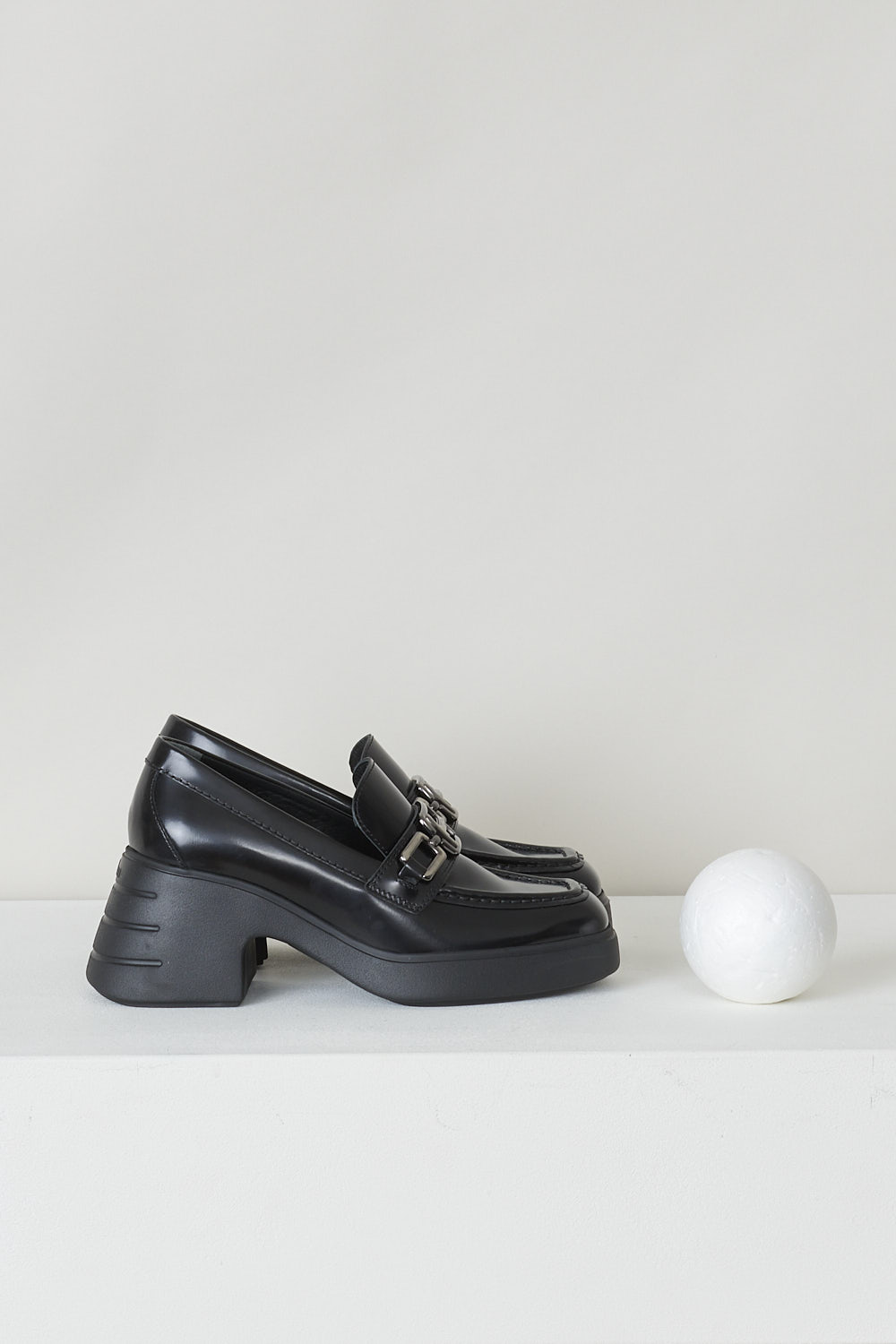 HOGAN, BLACK HEELED MOCCASINS, HXW6180EP40RWWB999_H618_MOCASSINO_ACCESSORIO, Black, Side, These slip-on loafers have a squared off toe with toe stitching and an silver-tone H-shaped buckle over the upper side. The loafers have a chunky black sole. 

