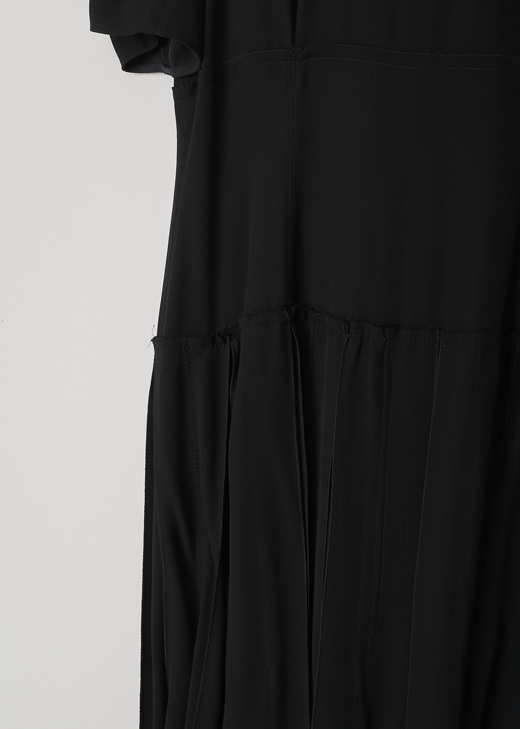 MARNI, BLACK DECONSTRUCTED DRESS, ABMA0096FY_TV285_00N99, Black, Detail, This black deconstructed dress has a round neckline and short puff sleeves. The dress has a paneled bodice with exposed seams and raw edges and a box pleated skirt. A concealed centre zip in the back functions as the closure option.   
