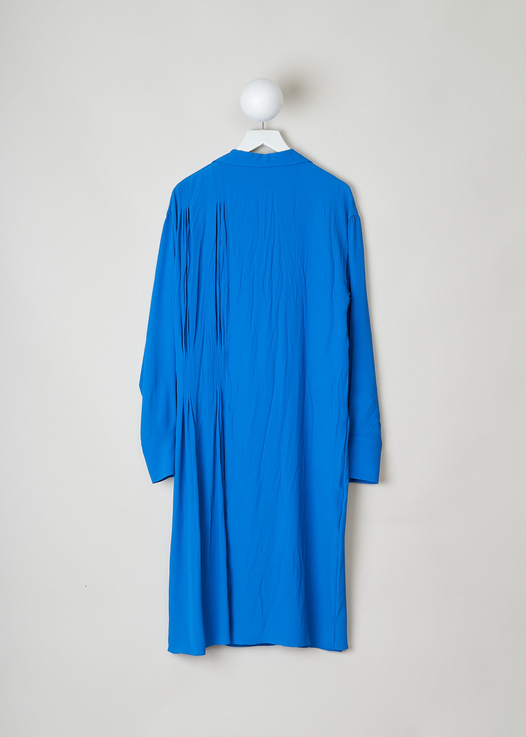 MARNI, ROYAL BLUE ASYMMETRICAL COLLAR DRESS, ABMA0171A0_TA089_00B57, Blue, Back, The royal blue dress features a notched lapel and a split neckline. The long sleeves have buttoned cuffs. The dress is mid-length and has a wider fit. A pleated detail can be found on one side and the dress has a layered skirt. 
