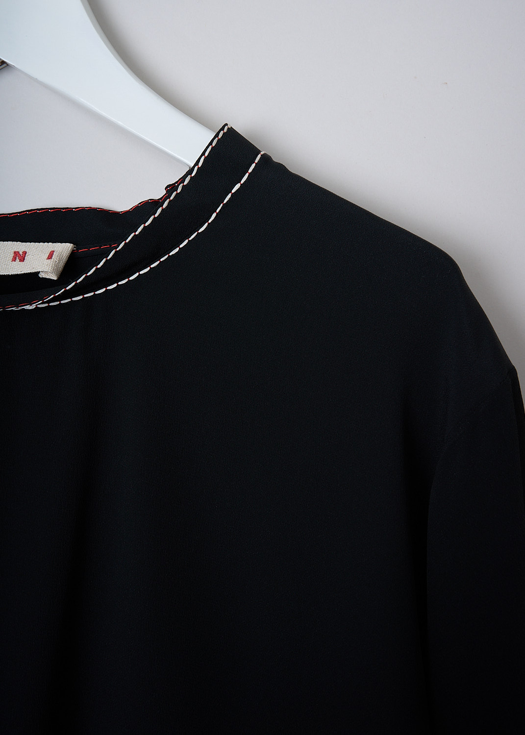 MARNI, BLACK WASHED CRÊPE TOP WITH CONTRAST STITCHING, CAMA0015M1_TA089_00N99, Black, Detail, This black washed crêpe top has round neckline with white and red stitching. The top has short sleeves and an asymmetric hemline with small slits. 
