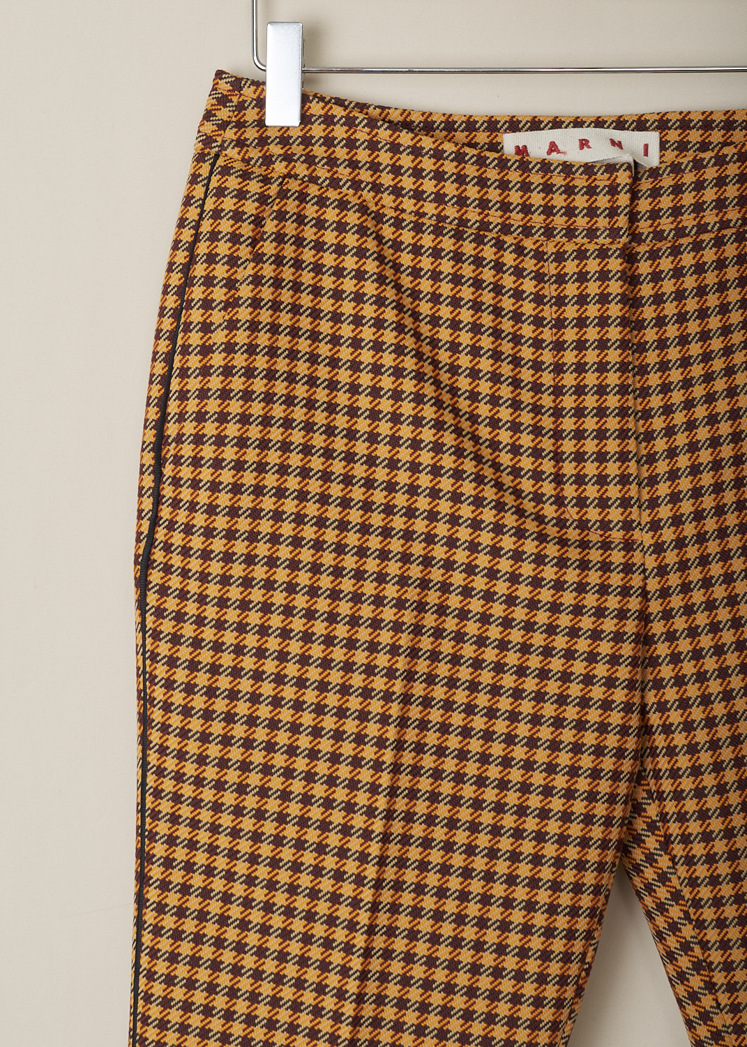 MARNI, ORANGE HOUNDSTOOTH PANTS, PAMA0341IM_UTP730_CHR79, Orange, Print, Detail, These mid-rise orange Houndstooth pants has a narrow waistband and a concealed clasp and zip closure. These pants have slanted pockets in the front and welt pockets in the back. Black piping runs along the side seams and centre creases run along the length of the pant legs. 
