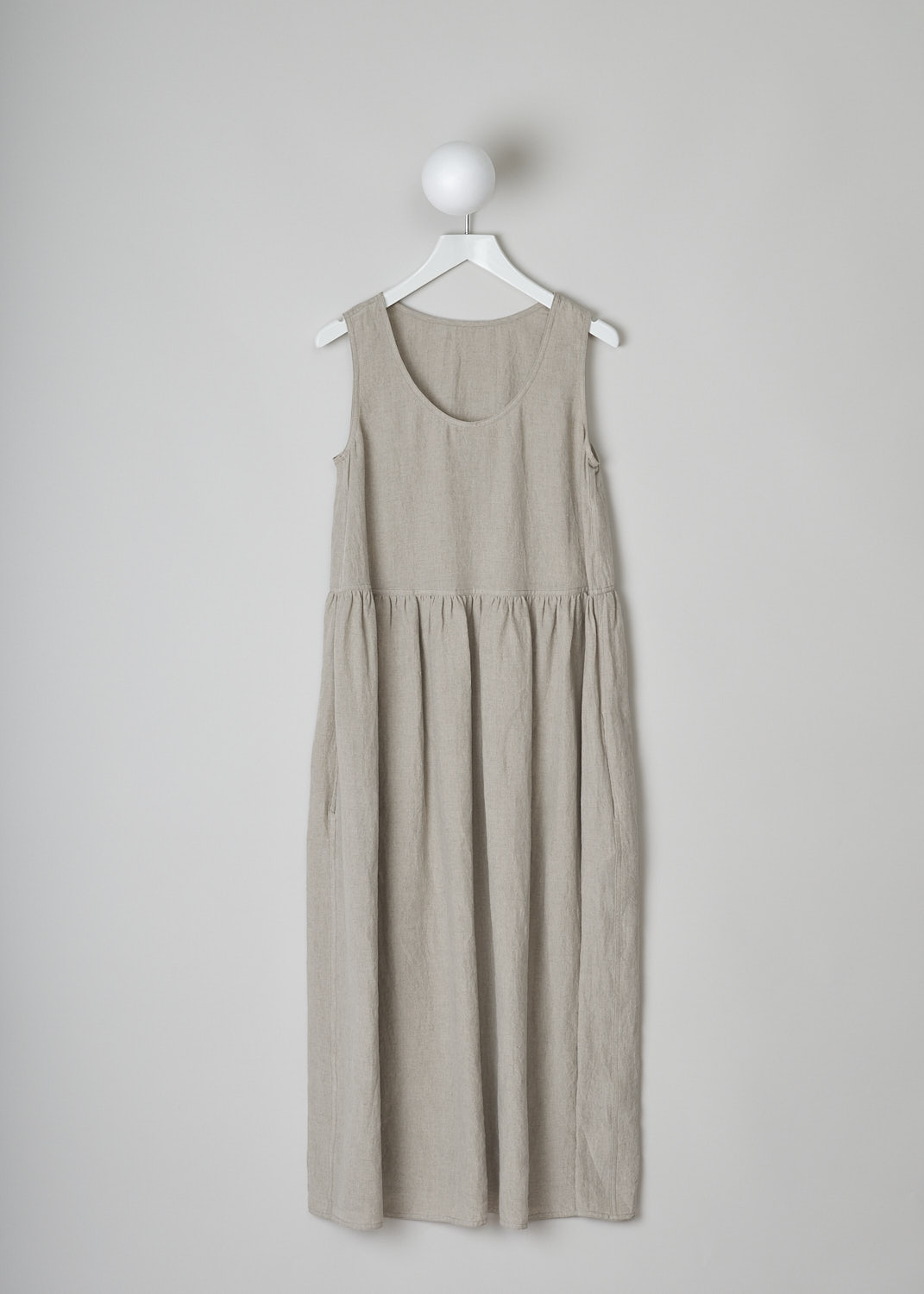 SOFIE D’HOORE, BEIGE LINEN DRESS, DANDLE_LIFE_NATURAL, Beige, Grey, Front, This beige sleeveless dress has U-neckline. The dress has a wide A-line silhouette. A straight crystal pleated hemline separates the bodice from the midi length skirt. Concealed slanted pockets can be found in the side seam. 
