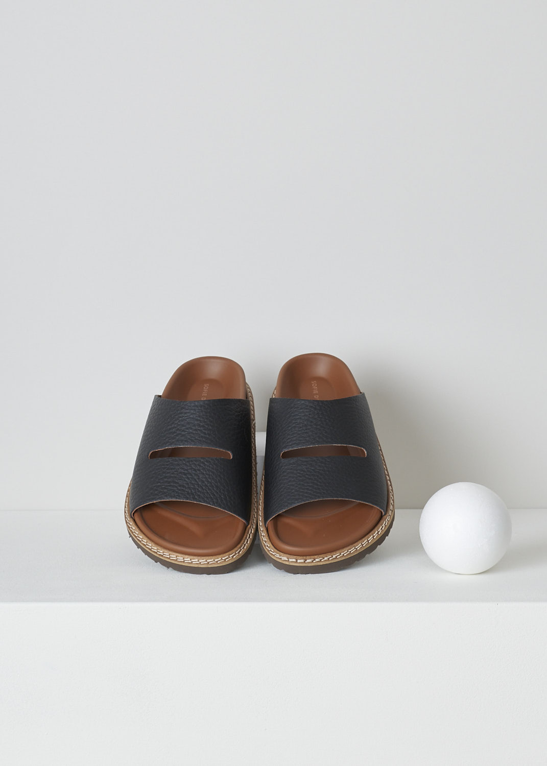 SOFIE Dâ€™HOORE, FABIA SLIP-ON SANDALS IN BLACK, FABIA_LNAT_BLACK, Black, Top, These slip-on sandals in the black have a wide footbed with stitching along the soles. A broad strap with a horizontal cut-out goes across the vamp. These sandals have a round open-toe.
