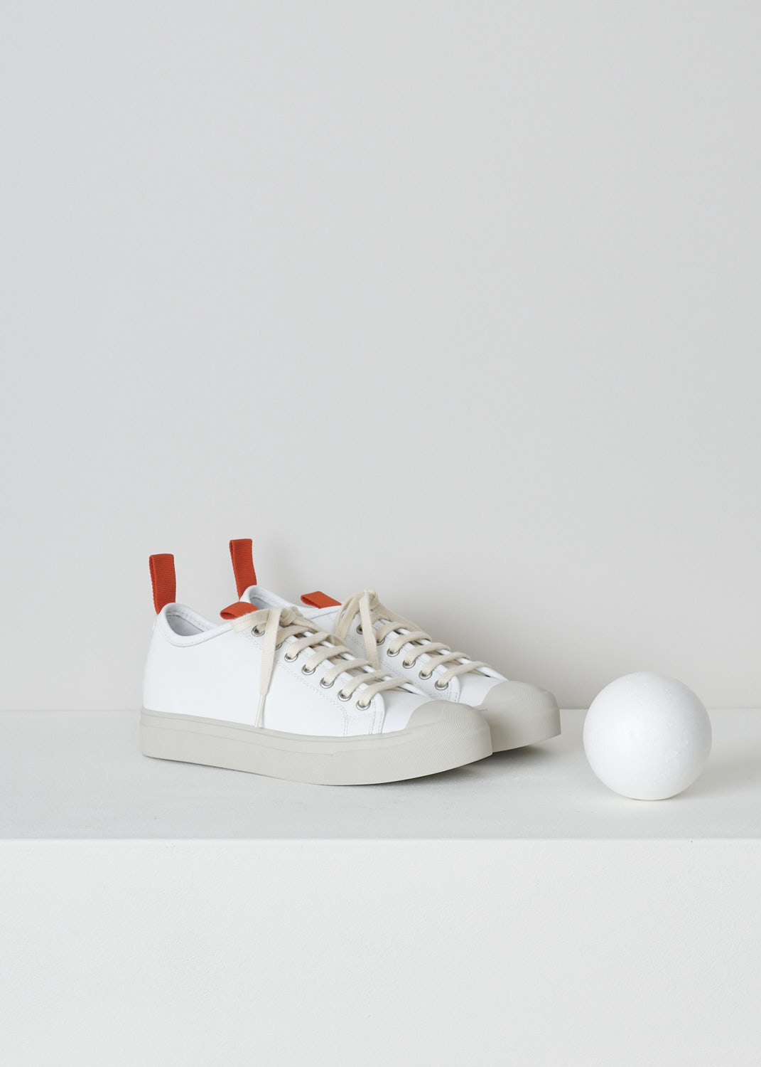 SOFIE Dâ€™HOORE, WHITE LEATHER SNEAKERS WITH RED ACCENTS, FABLE_LCOL_WHCL, White, Front, These white leather sneakers feature a front lace-up closure with white laces. Red pull-tabs can be found on the back of the heel and on the front of the tongue. These sneakers have a round toe with a beige rubber toe cap that goes down into the rubber sole in that same beige color. 

