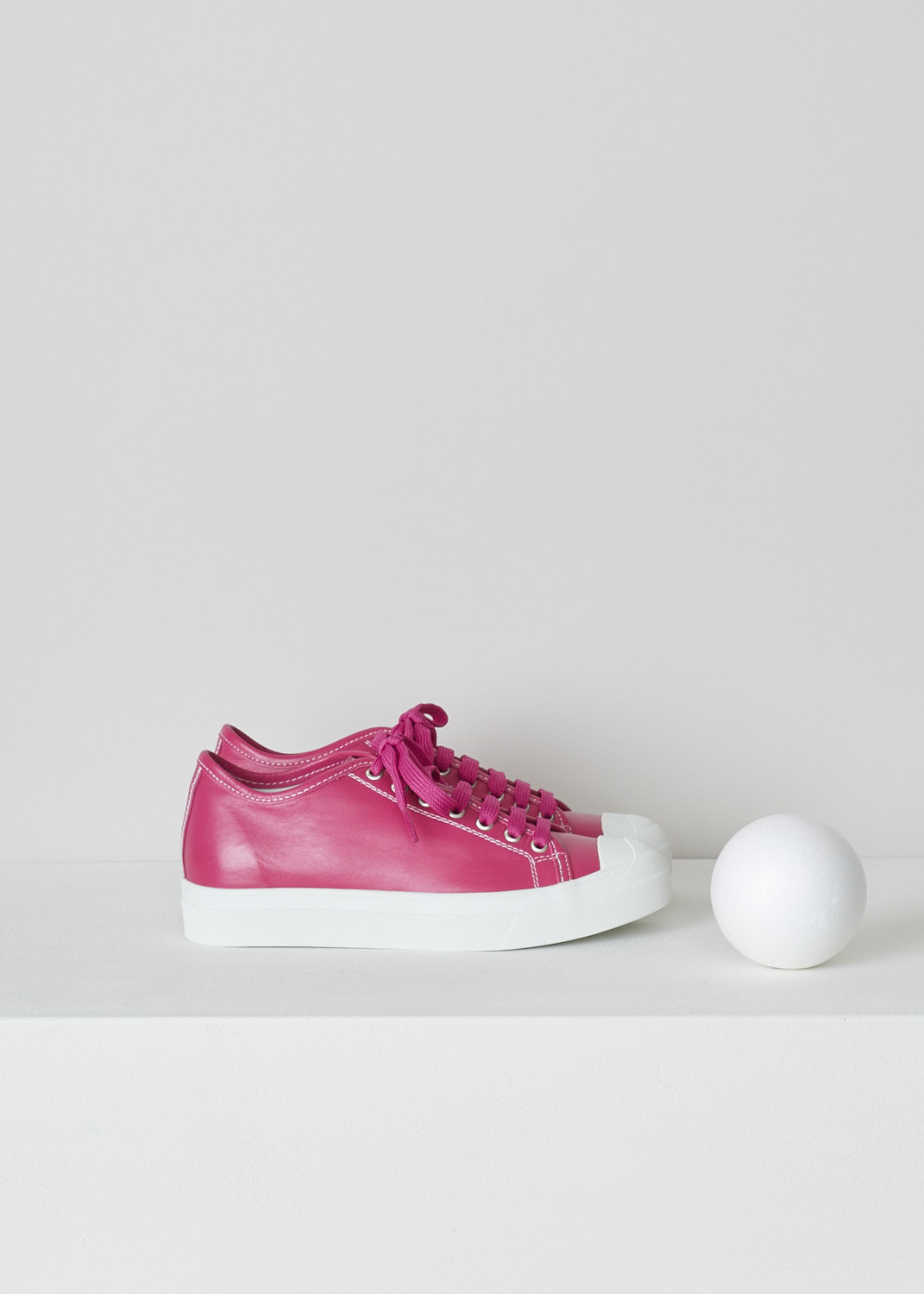 SOFIE Dâ€™HOORE, FUCHSIA PINK LEATHER SHOES, FOLK_LSNOW_FUCHSIA, Pink, Side, These fuchsia pink leather sneakers feature a front lace-up closure with pink laces. These sneakers have a round toe with a white rubber toe cap that goes down into the white rubber sole. Contrasting white stitching is used throughout. The sneakers come with an additional pair of laces in white.
