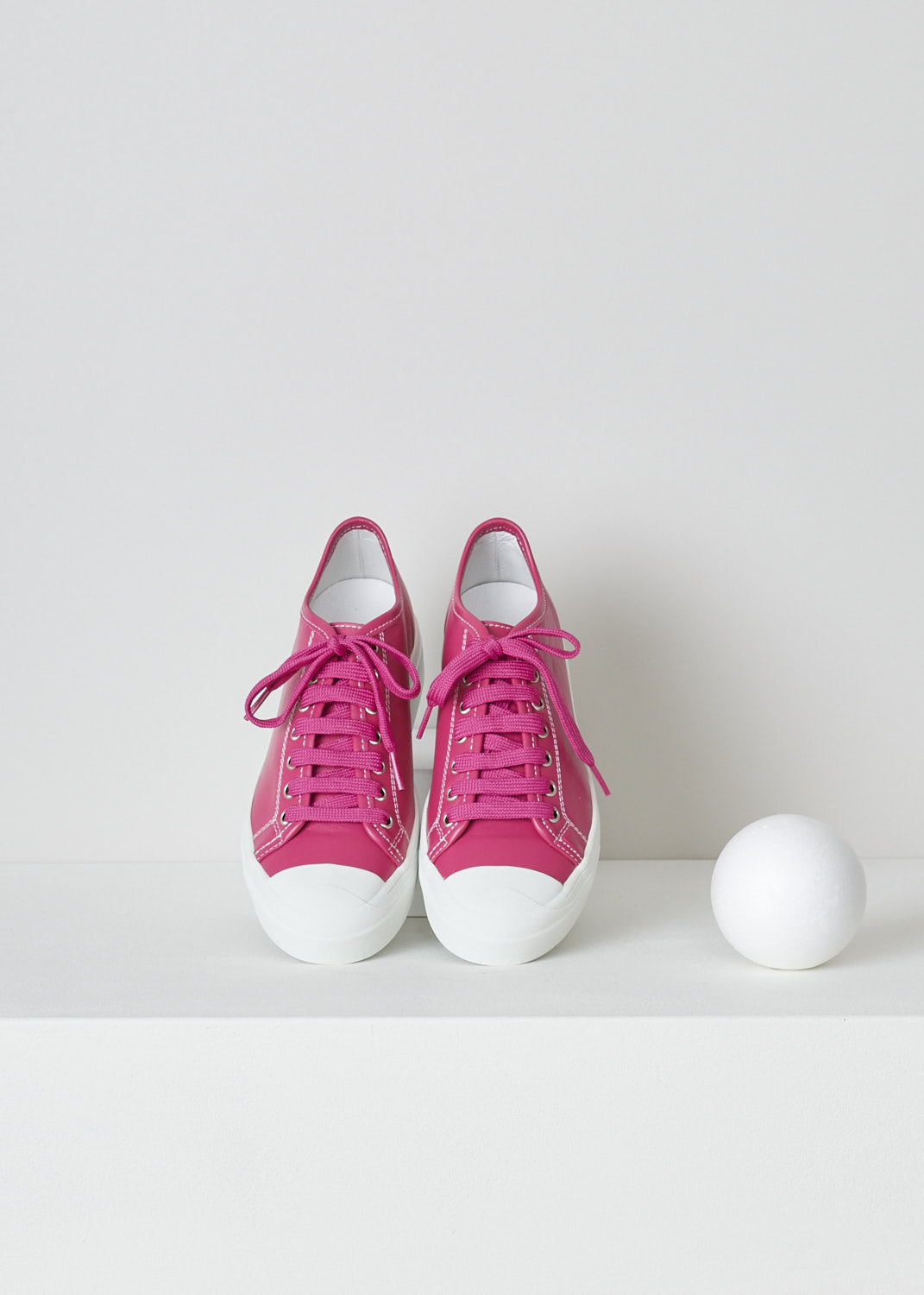 SOFIE Dâ€™HOORE, FUCHSIA PINK LEATHER SHOES, FOLK_LSNOW_FUCHSIA, Pink, Top, These fuchsia pink leather sneakers feature a front lace-up closure with pink laces. These sneakers have a round toe with a white rubber toe cap that goes down into the white rubber sole. Contrasting white stitching is used throughout. The sneakers come with an additional pair of laces in white.
