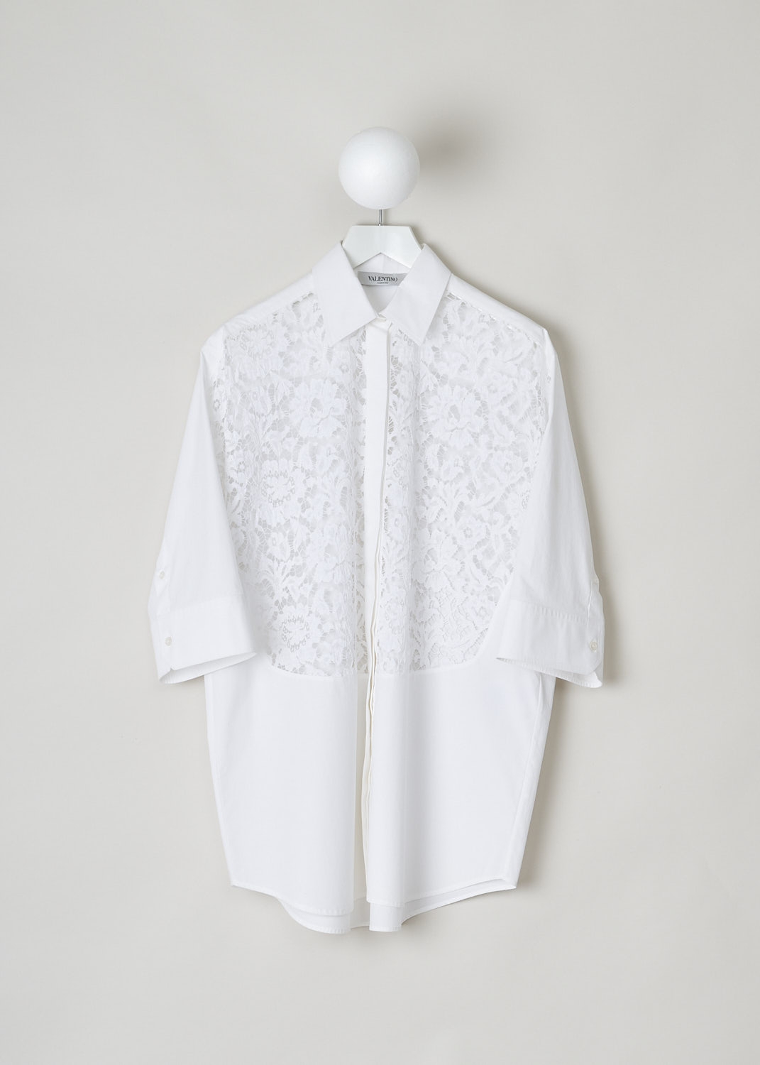 VALENTINO, WHITE TUNIC BLOUSE WITH LACE UPPER FRONT, WB3AB2P05A6_001, White, Front, This white tunic blouse has a classic collar and a concealed front button closure. The three quarter sleeves have buttoned cuffs. The upper front of the tunic is is made with see-through lace, extending partly to the sleeves. The tunic has a straight hemline. In the back, a centre box pleat can be found. The tunic has a wider silhouette. 
