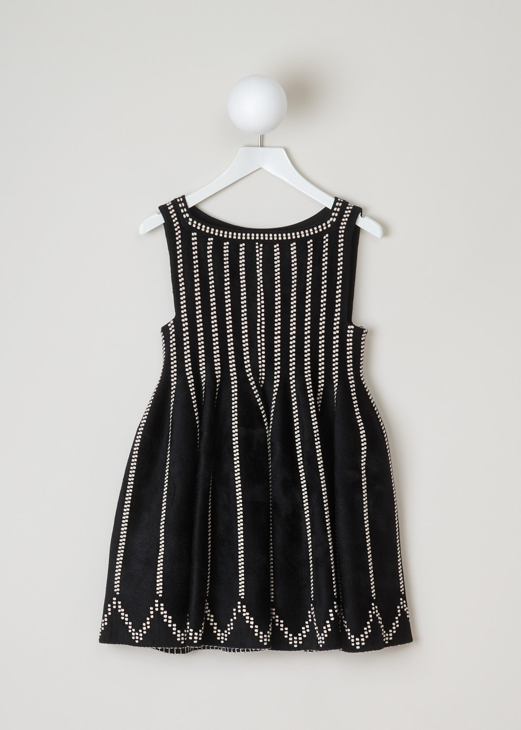 AlaÃ¯a, Black dotted mini-dress, 3H9R367CM071_robe_sm_glacier_velours_C962_noir_ivoire, black white, front, Ivory dots cover this thigh-high mini-dress. Featuring no sleeves and a boat neckline. Made with wool the fabric has a roughened wool feel, so it will keep you warm. The skirt has a zigzagging line of dots above the hem.