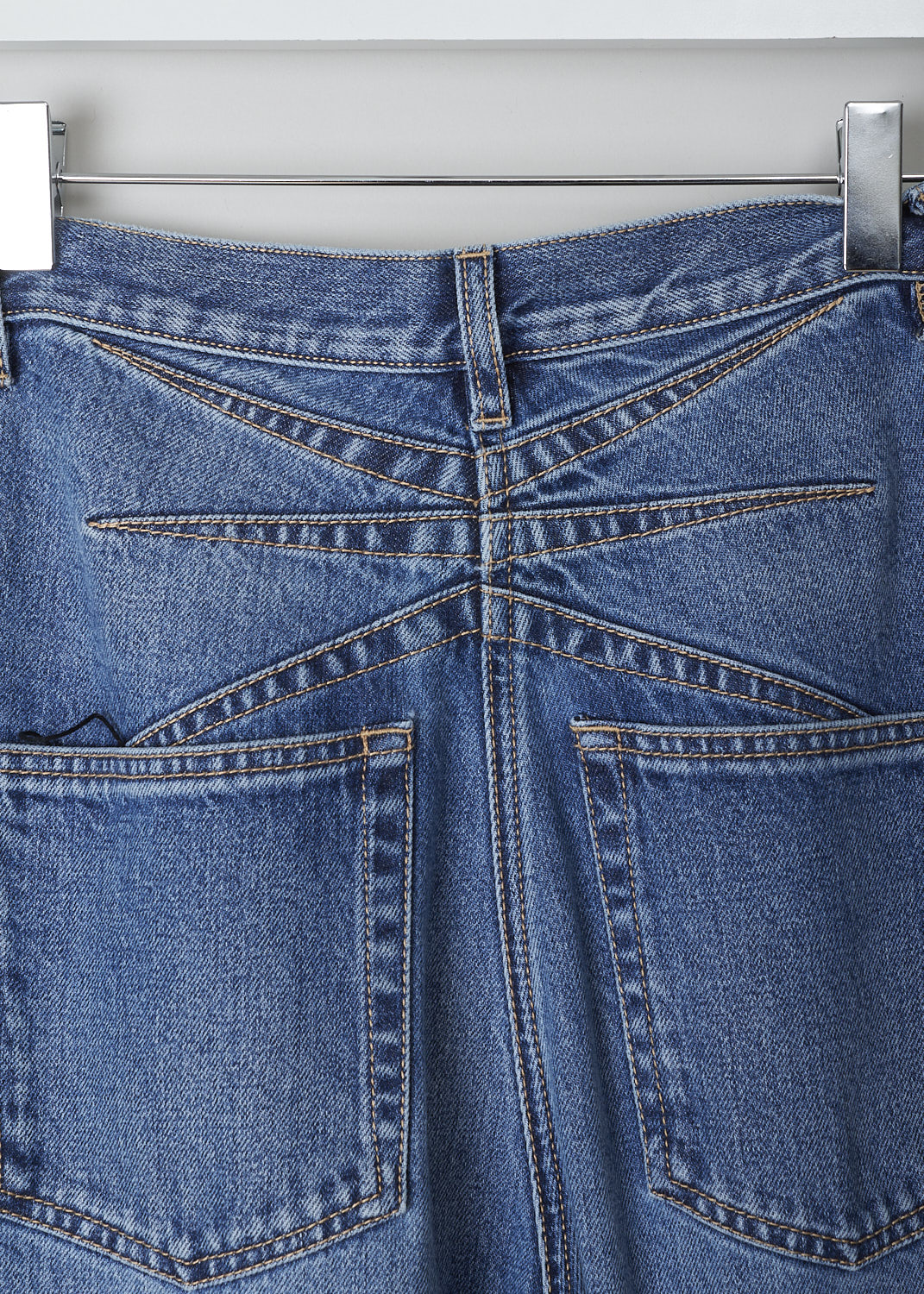 ALAÃA, FLARED BLUE DENIM JEANS, AA9P01032T441_CRINOLINE_JEANS, Blue, Detail, These high-waisted flared blue denim jeans are fitted to the knee before flaring out in a 70's flounce. These jeans have belt loops, a front button and zip closure and slanted pockets. In the back, these pants have patch pockets and decorative seams. 
