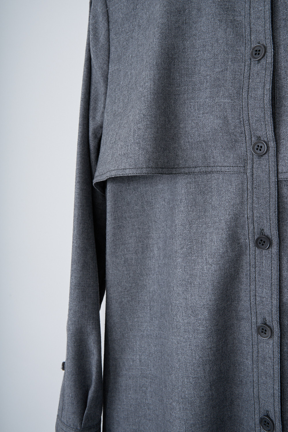 ASPESI, GREY WOOL SHIRT DRESS, 2902_L629_01190, Grey, Detail, This grey wool-blend shirt dress has a classic collar and a button placket in the front that goes down to the hemline. The long sleeves have buttoned cuffs. The dress has epaulettes on the shoulders and a storm shield front. The dress has small belt loops and slanted pockets are concealed in the side seam. The dress has a straight hemline. In the back, the dress has a storm shield with an inverted pleat. 
