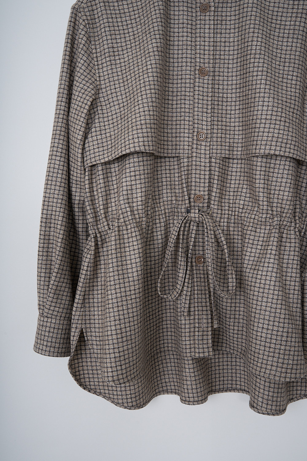 ASPESI, BROWN CHECKERED BLOUSE WITH DRAWSTRING DETAIL, 5457_L629_42132, Brown, Print, Detail, This brown checkered blouse has a classic collar and a button placket in the front. The long sleeves have buttoned cuffs. The blouse has a storm shield across the chest that extends to the back. A drawstring can be used to cinch in the waist. The blouse has a curved hemline.
