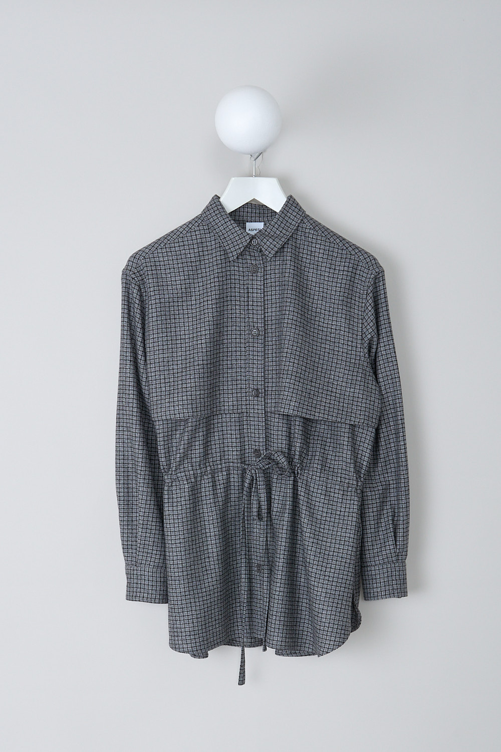 ASPESI, GREY CHECKERED BLOUSE WITH DRAWSTRING DETAIL, 5457_L629_42173, Grey, Print, Front, This grey checkered blouse has a classic collar and a button placket in the front. The long sleeves have buttoned cuffs. The blouse has a storm shield across the chest that extends to the back. A drawstring can be used to cinch in the waist. The blouse has a curved hemline.
