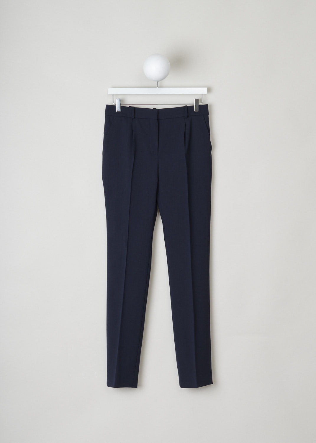 Balenciaga, Pleated navy pants, 413371_TQI08_8065, blue, front, Navy pants comes adorned with pleats and froward slanted pockets on the front. Featuring a slightly tapered fit throughout the legs and decorating the back are two welt pockets. The fastening option here comes in the form of zipper, metal clip and bearer button. 