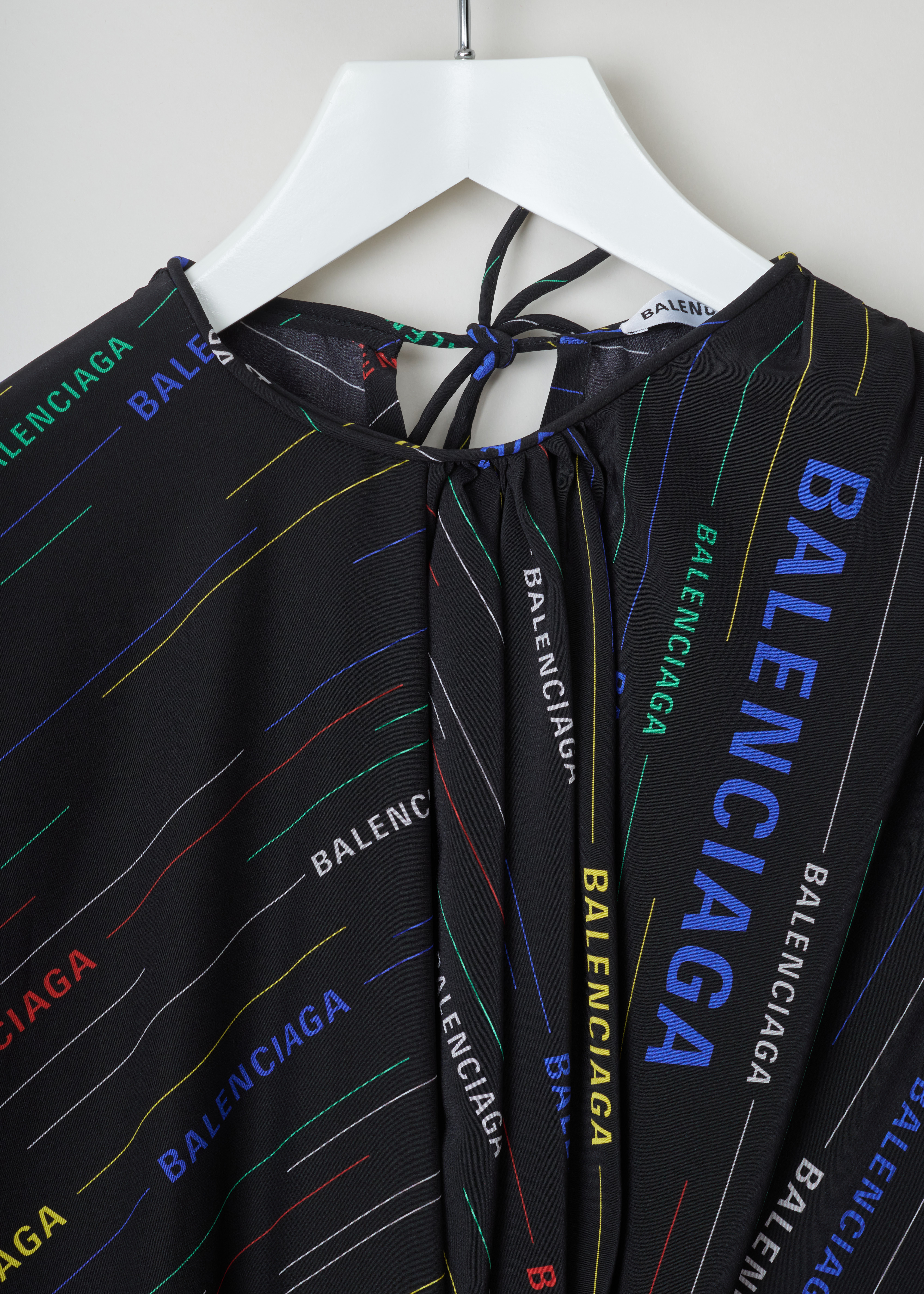 Balenciaga Logo printed dress 556343_TDL55_2771 black multicolour detail. Black silk dress with multicolour diagonal logo print, gathered rounded neckline, buttoned cuffs and a self-tie bow fastening on the back.