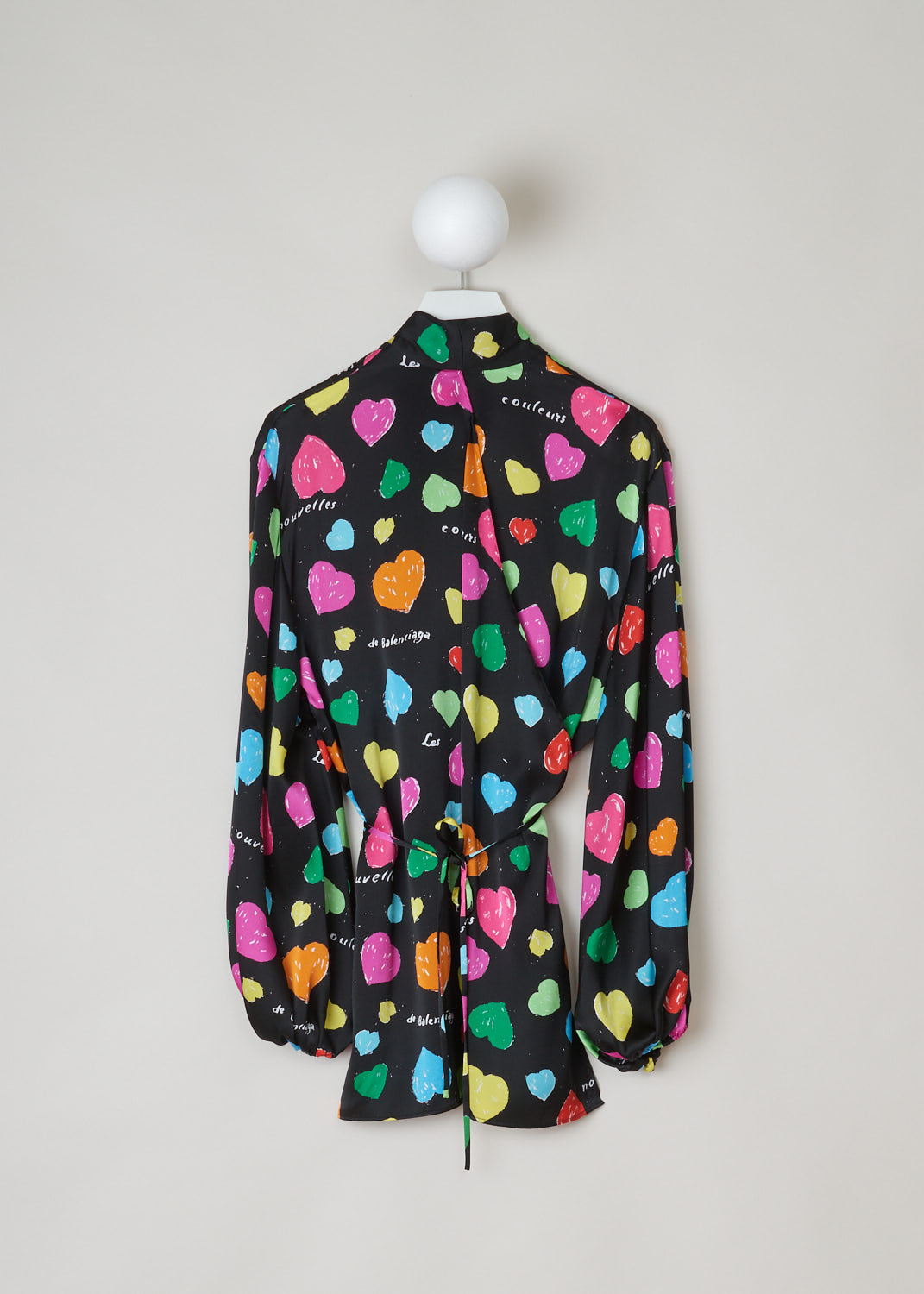 Balenciaga, Archive hearts print blouse, WL0_659088_TKL08_1000, black, pink, green, yellow, blue, print, back, This blouse features an archive hearts and text print which stands out against the black silk background. It has a self tie collar and a belted waist. The blouse also has long sleeves with elasticated cuffs. 
