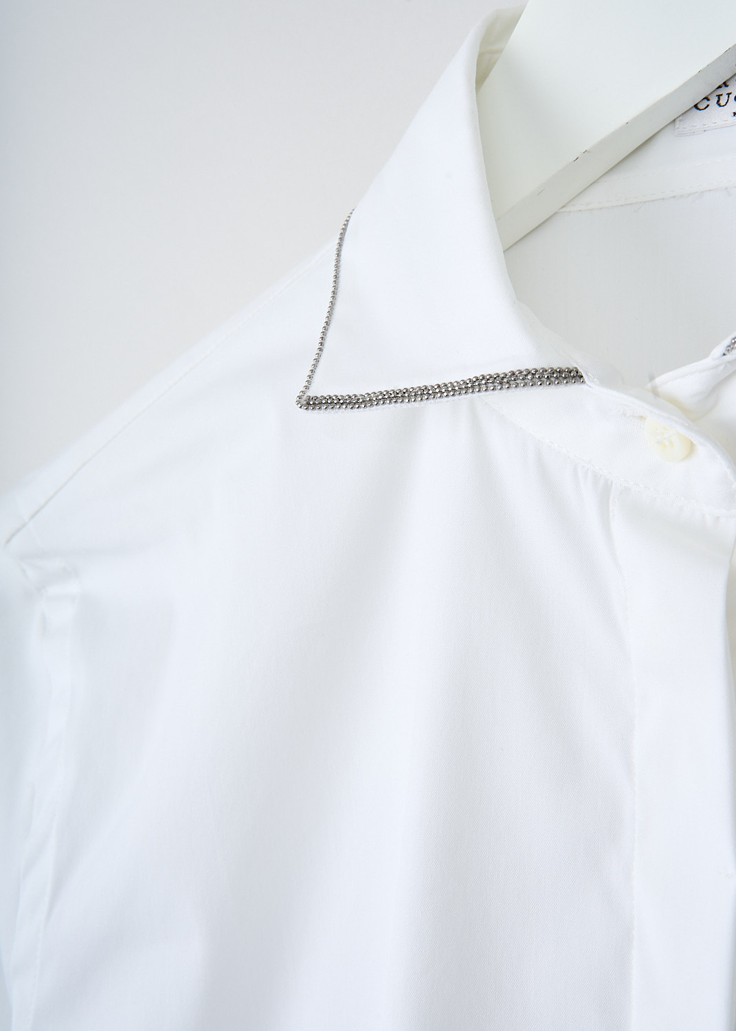 Brunello Cucinelli, White blouse with monili decorated cutout collar, M0091NB426_C159, White, Detail, This white blouse has a cutout collar which is subtly decorated with a monili beaded trim. The blouse has a concealed front button closure. The long sleeves have buttoned cuffs. The blouse has a rounded hemline.
