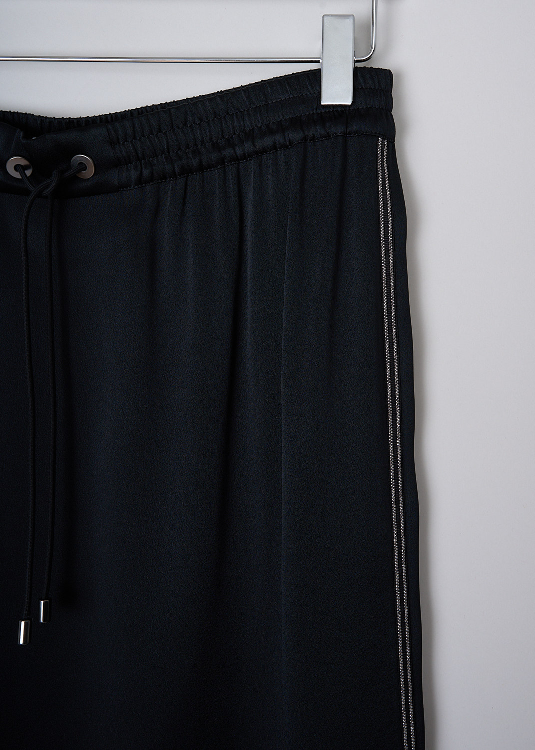 BRUNELLO CUCINELLI, SPORTY BLACK SATIN MIDI SKIRT, M0H60G2687_C101, Black, Detail, This sporty black satin midi skirt has an elasticated waistband with a drawstring closure. Monili-beaded trim run down the side seams. The skirt has a rounded high-low hem, with the back being longer than the front.
