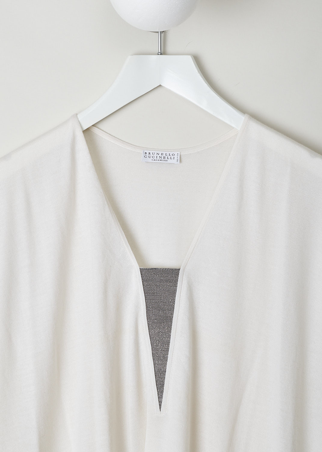BRUNELLO CUCINELLI, CREAM COLORED TOP WITH MONILI V-NECKLINE, M13865822_C159, White, Detail, This cream colored cap sleeve top is made with a lightweight cashmere blend. The top has a deep V-neckline that is decorated with the brand's signature monili beads. The hemline has a ribbed finish. 
