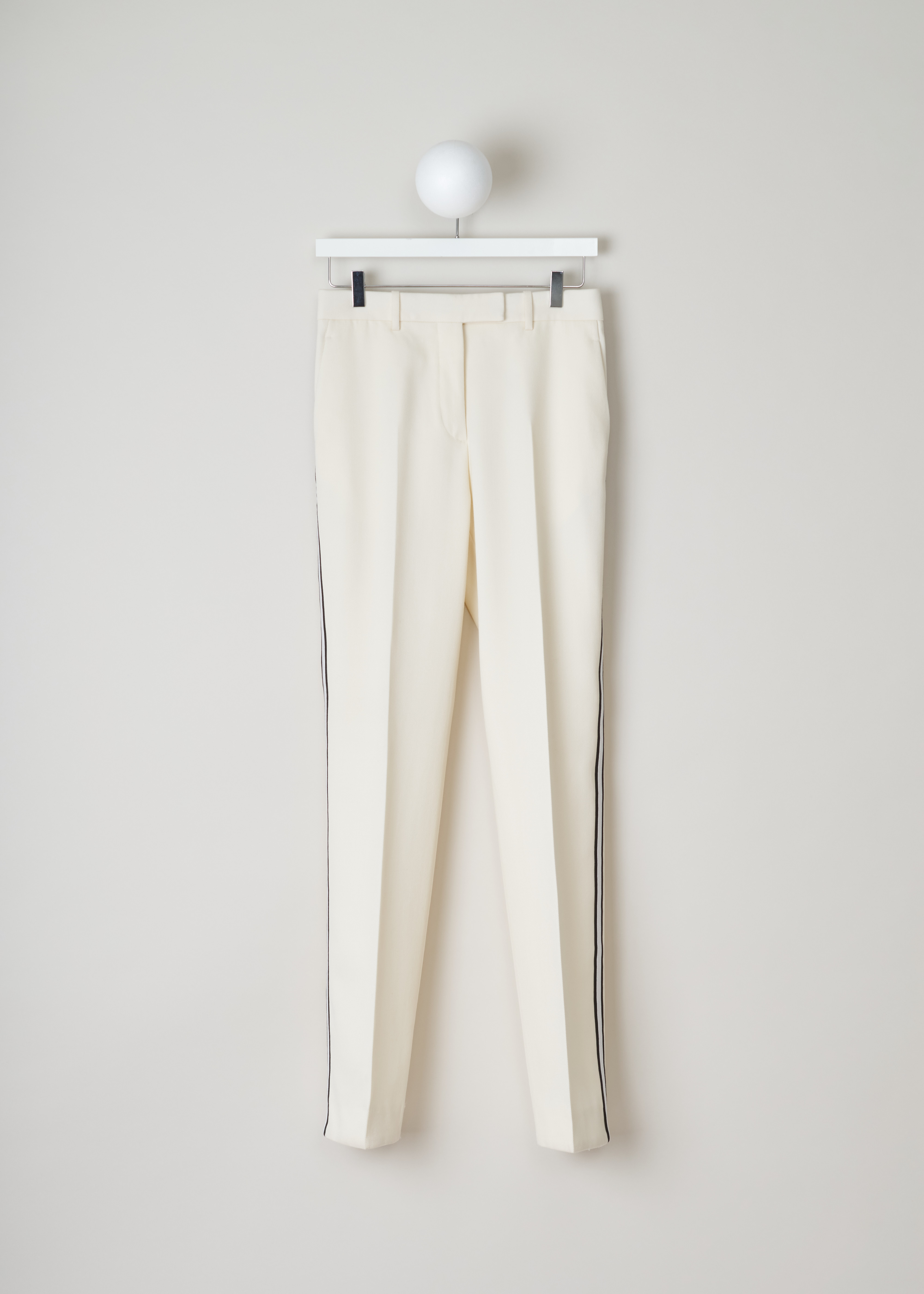 Calvin Klein 205W39NYC White pants with ribbon trim 84WWPB22_W037_197 off-white front. Off-white wool pants with a white and black side ribbon trim.
These straight pants have two slant pockets on the front and a welt pocket on the back.
