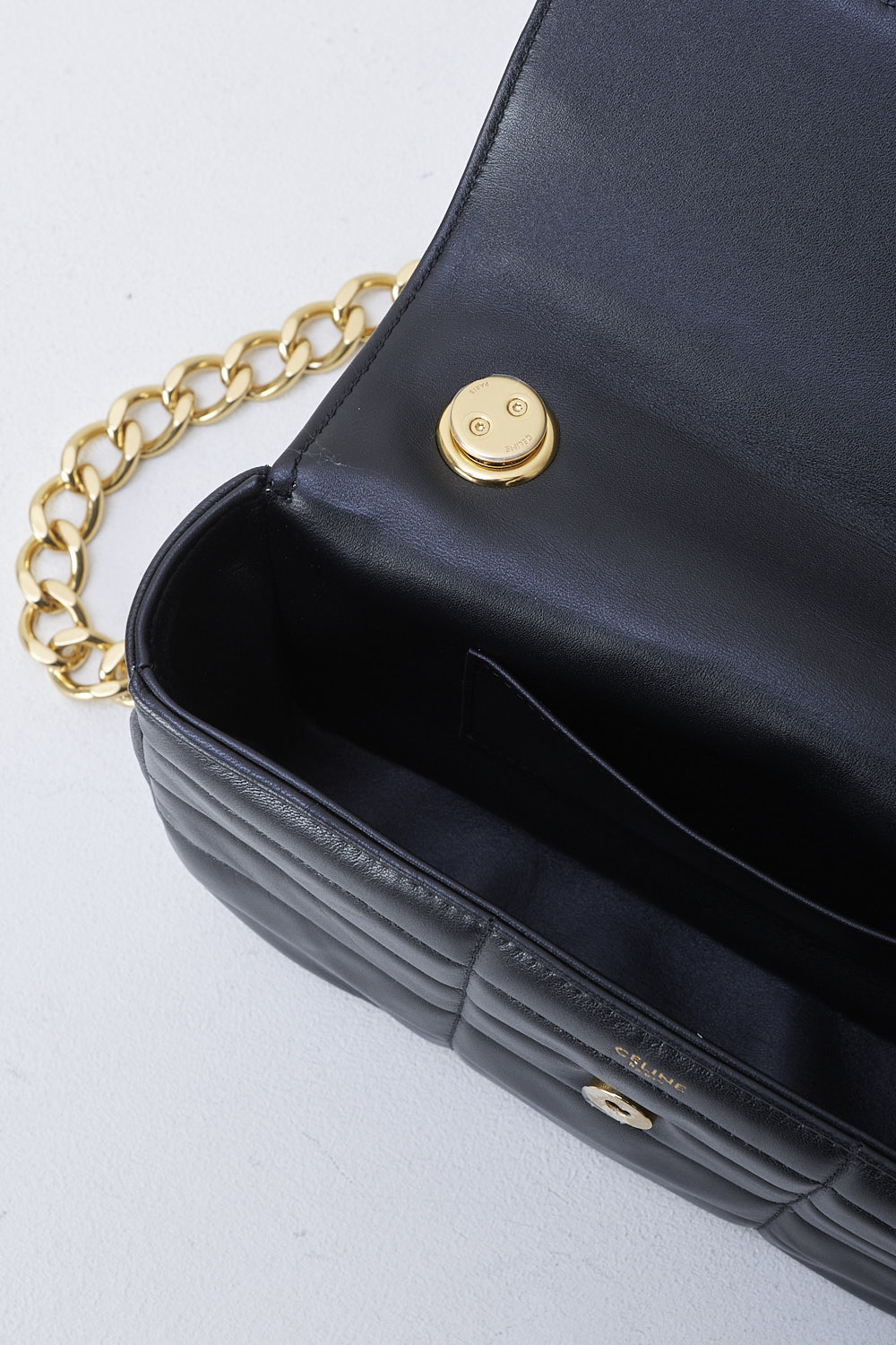 CELINE, BLACK MATELASSÉ SHOULDER BAG WITH GOLD CHAIN, 111273EPZ_38NO, Black, Detail 1, This black matelassé shoulder bag has gold-tone metal hardware with the brand's lettering on the front and a gold chain shoulder strap. The bag has a snap button closure. The flap opens to the main compartment with a inner pocket to the backside


