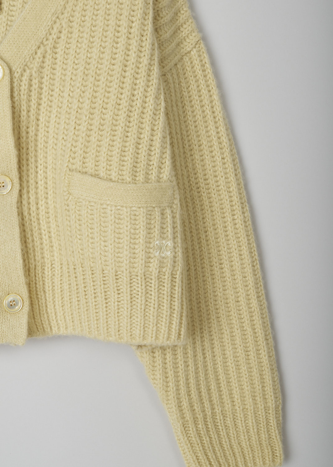 CELINE, PALE YELLOW CASHMERE CARDIGAN, 266R_2A49X_11PY,  Yellow, Detail, This pale yellow cashmere cardigan has a V-neck with a front button closure. The cardigan has dropped shoulders. In the front, the cardigan has two patch pockets. 
