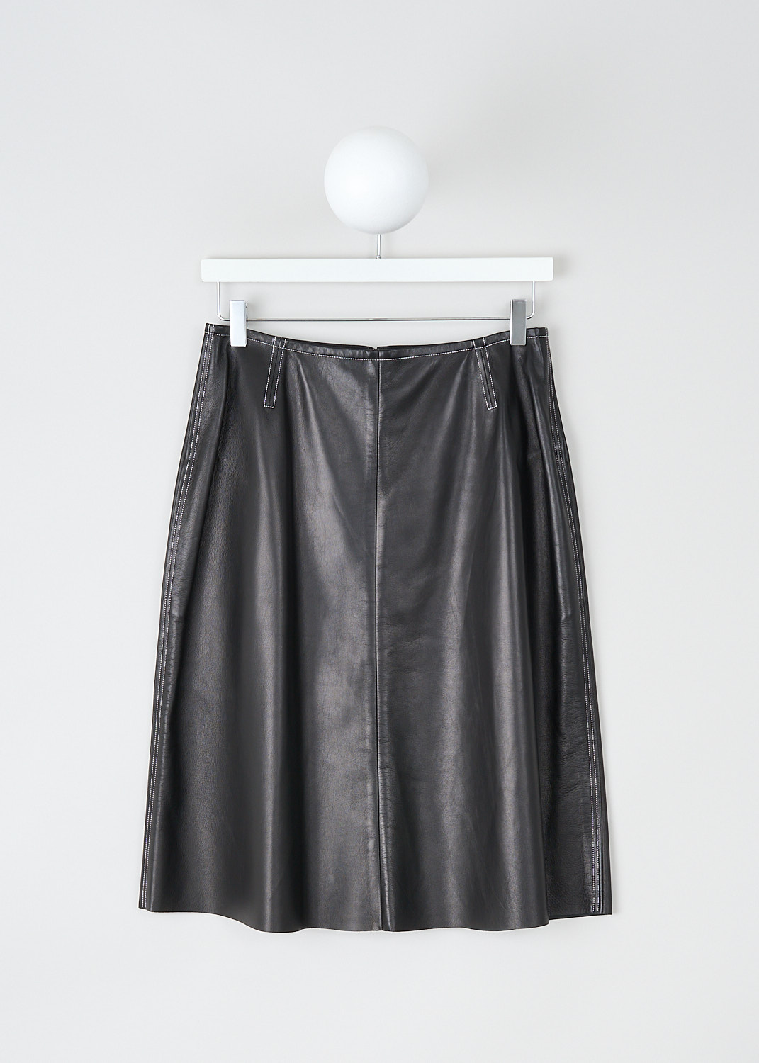 Celine, Flared black leather skirt, 6828_22N21_0N0, Black, Front, This flared black leather skirt has an A-line silhouette. A concealed centre zip in the back functions as the closure. The skirt has concealed slanted pockets. Contrasting white stitching has been used throughout. 
