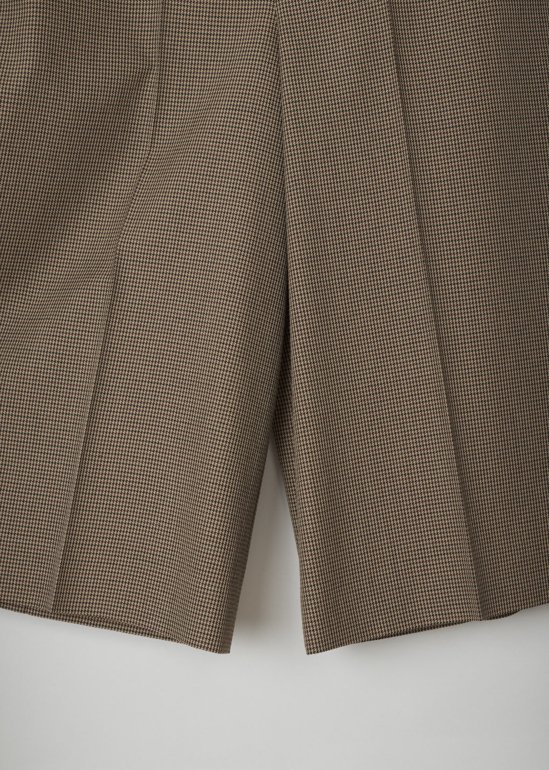 CELINE, BROWN HOUNDSTOOTH CULOTTES, 868H_2P233_28BZ, Brown, Print, Detail, Brown Houndstooth culottes made from wool. These pants have belt loops and the closing option on this model is a concealed hook, button and zipper option. In the front, along the length of the pants, a front pleat can be found. These pants have slanted pockets in the front and two welt pockets in the back.
