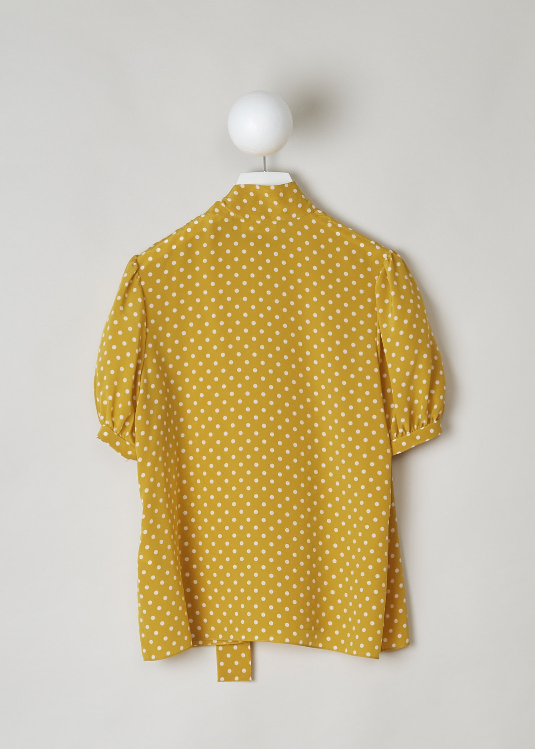 CELINE, MUSTARD YELLOW POLKA DOT TOP WITH PUSSY BOW, 966H_2B606_11TC, Yellow, Print, Back, This mustard yellow top has a white polka dot print. The top has a high neck with a pussy bow to one side. The top has short puff sleeves. The closure option is a concealed zipper on the left shoulder.   
