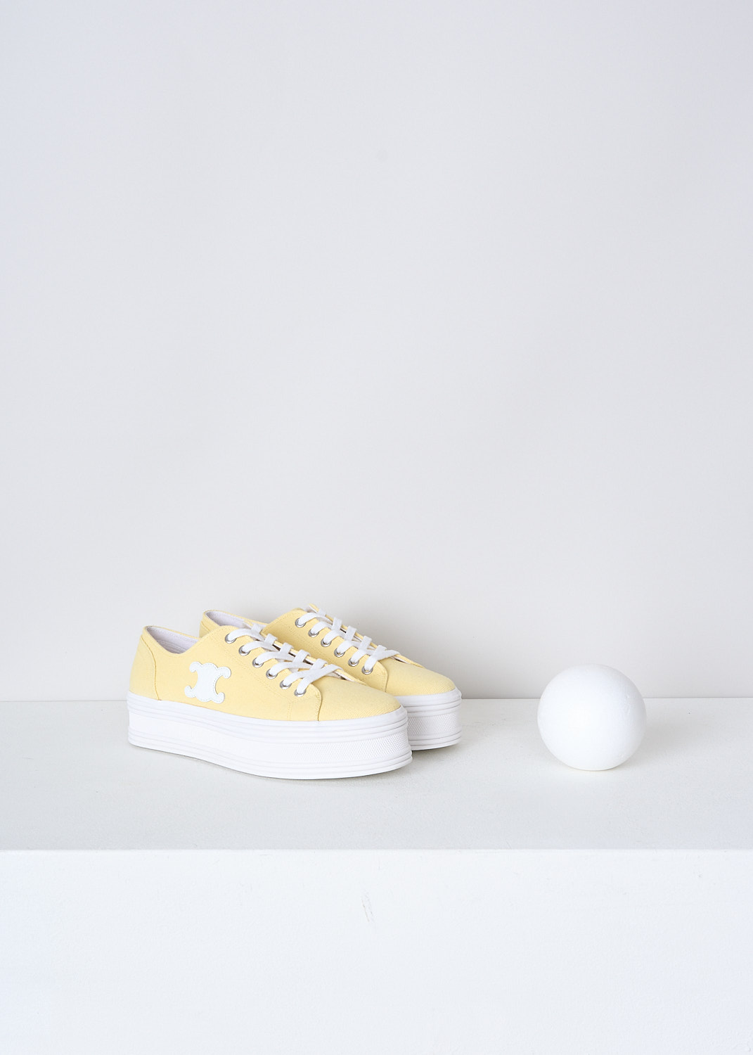 CELINE, BUTTER YELLOW CANVAS JANE SNEAKERS, 346272220C_11LY, Yellow, Front, These butter yellow canvas Jane sneakers feature a front lace-up fastening with white laces. The brand's Triomphe logo patch can be found on the side in white. These sneakers have white platform soles. 
