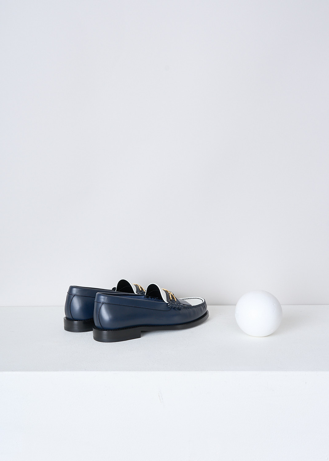 CELINE, TWO-TONE LEATHER LOAFERS, 337773001C_07NJ, White, Blue, Back, These two-tone leather loafers in navy and white have a round toe with  fringed tassels and a gold-tone buckle with the brand's logo on the vamp. Around the trim, the leather is subtly pleated.


