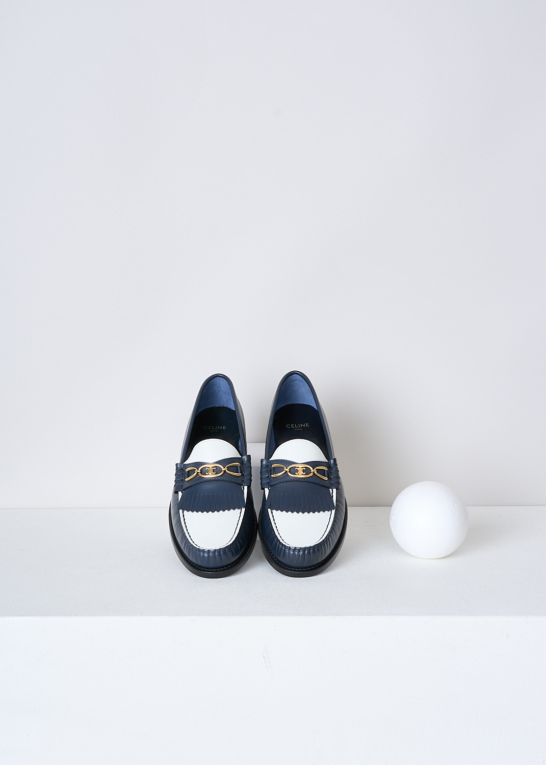 CELINE, TWO-TONE LEATHER LOAFERS, 337773001C_07NJ, White, Blue, Top, These two-tone leather loafers in navy and white have a round toe with  fringed tassels and a gold-tone buckle with the brand's logo on the vamp. Around the trim, the leather is subtly pleated.


