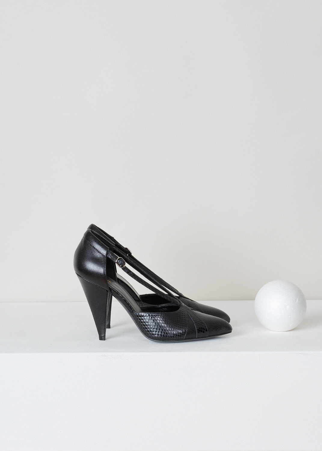 Celine, Decussate-strap triangle heel pumps, 332934096C_38NO_criss_cross_pump, black, side, Black leather embossed with a snakeskin pattern, featuring a crisscross strap which lead up from pointed toe section to the heel. Designed with a triangular shaped heel and has a silver-tone buckle as your fastening option. 

Heel height: 10 cm / 3.9 inch. 