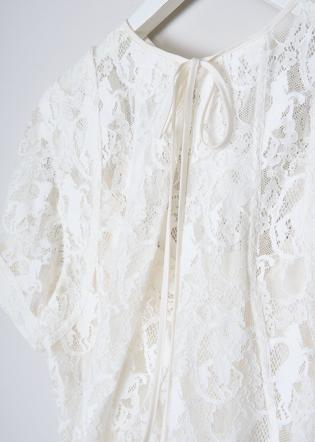 CHLOÉ, LACE MIDI DRESS IN ICONIC MILK, CHC19SRO41416107_ICONIC_MILK, White, Detail, This lace midi dress in Iconic White has a round neckline and short sleeves. The dress has an asymmetric hem. In the back, a drawstring functions as the closure and creates a kick pleat on the back. The dress comes with a white slip dress.  

