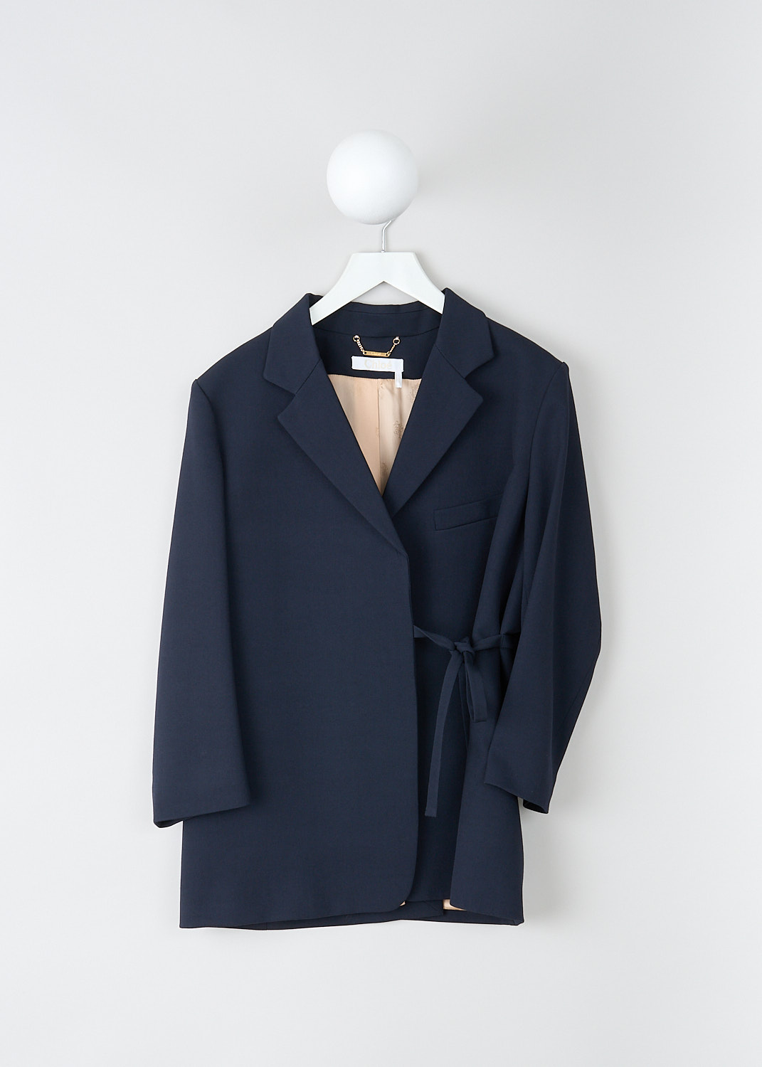 Chloé, Midnight blue wrap-style jacket, CHC19SVE050674A7, Blue, Front, This midnight blue wrap-style jacket features a notched lapel and a single breast pocket. The closure option is a wrap belt to one side. The blazer has three-quarter sleeves. In the back, the jacket has a high slit. 
