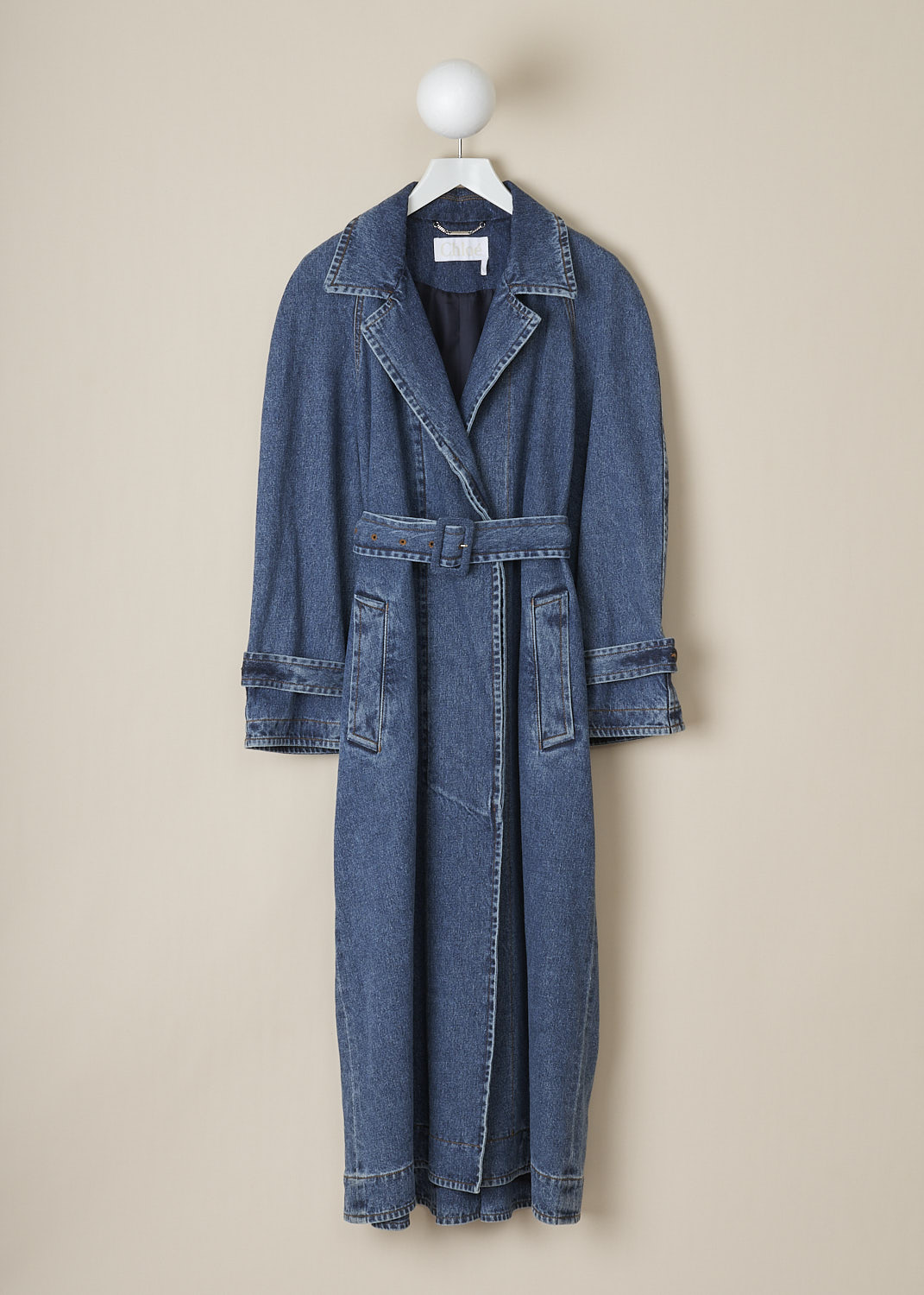 CHLOÃ‰, LONG DUSKY BLUE DENIM COAT, CHC23SDM2716740X_DUSKY_BLUE, Blue, Front, This long dusky blue denim trench coat has a notched lapel. The coat has a concealed front button closure and a matching fabric belt to cinch in the waist. The long sleeves have sleeve straps. The coat has slanted pockets. In the back, the coat has a centre kick pleat.

