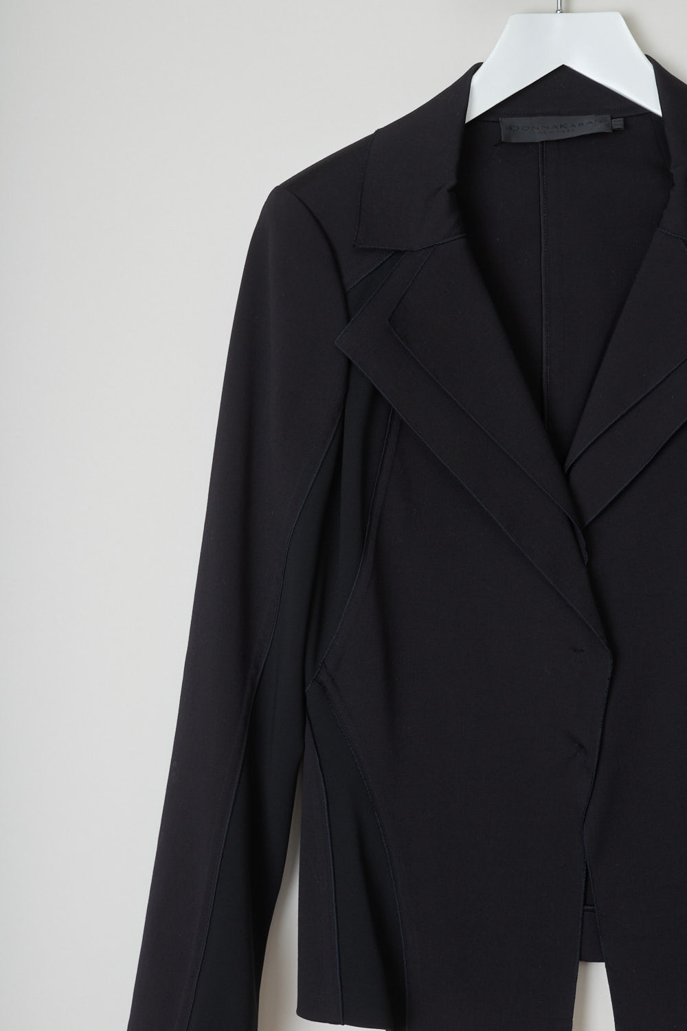 Donna Karan, black double lapel jacket, A42J238073_001_black, black, detail, Black jacket comes with a pointed collar and double lapels. Featuring long sleeves and has backing buttons on the front as your closure option. This jacket is made up from two kinds of fabrics a stretchy kind and a regular kind, and placed in a certain way where the jacket stretches where needed. 
