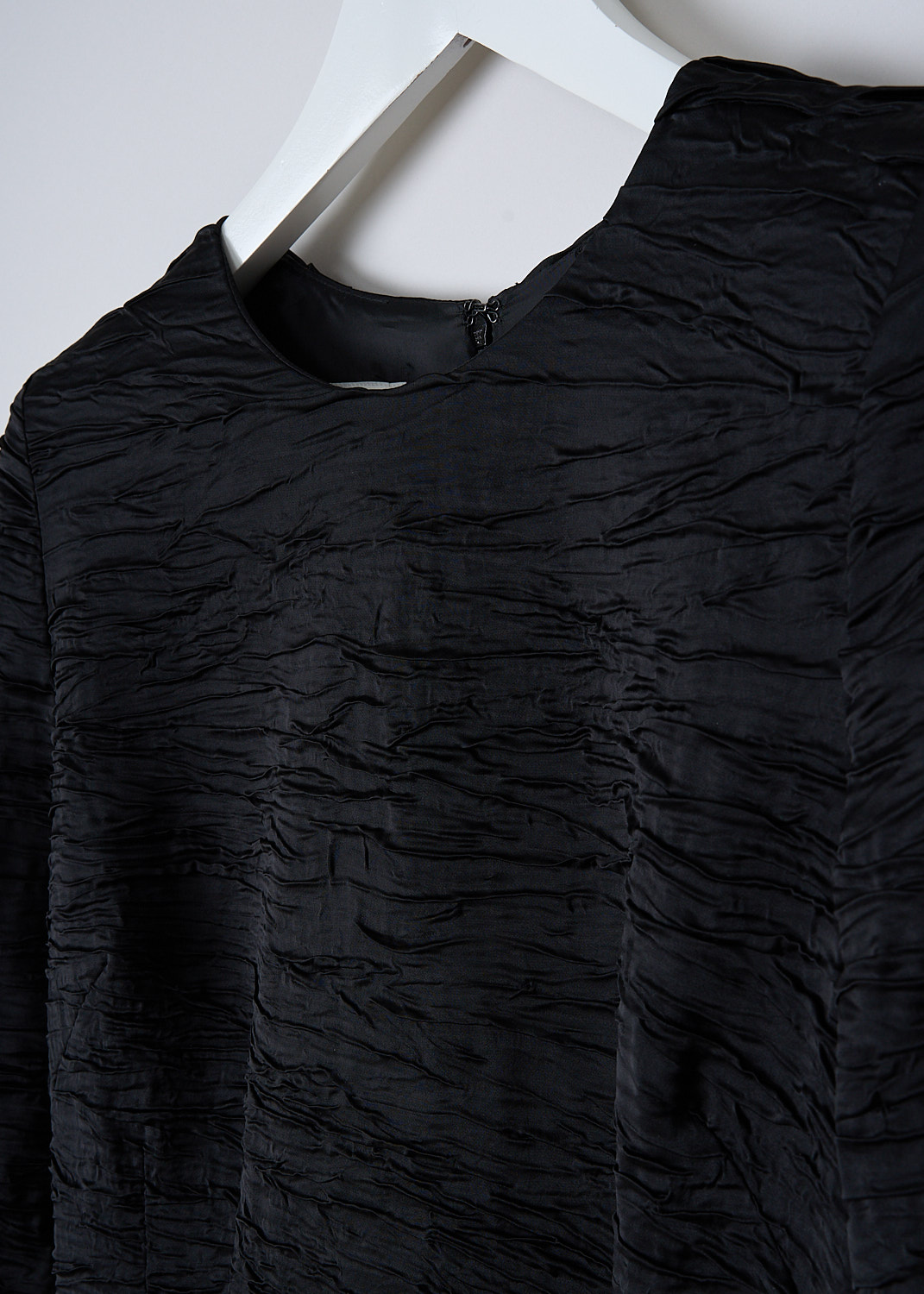 DRIES VAN NOTEN, BLACK RUCHED DELAVINAS DRESS, DELAVINAS_5263_WW_DRESS_BLA, Black, Detail, This black Delavinas sheath dress is made in a textured ruched fabric. The dress has a round neckline and long sleeves with shoulder pads. In the back, a concealed centre zip functions as the closure. Also in the back, the dress has a centre slit. The dress has a fitted silhouette with a straight hemline. 
