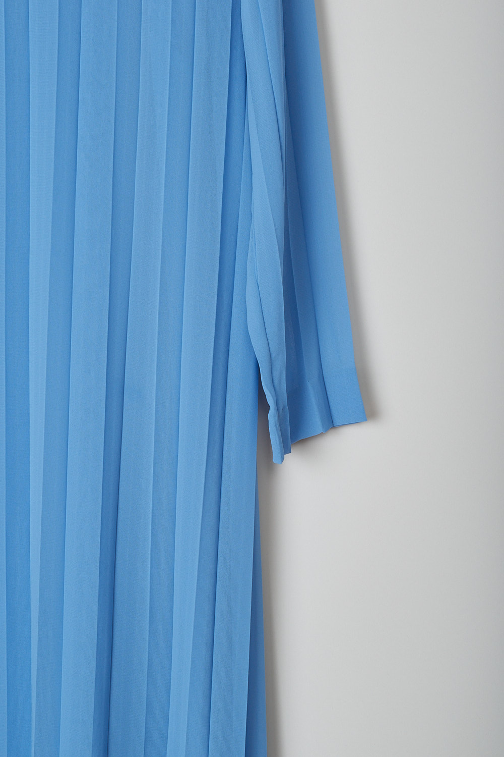 DRIES VAN NOTEN, SKY BLUE PLEATED DELAVITA DRESS, DELAVITA_6265_WW_DRESS_SKY, Blue, Detail, This sky blue semi sheer Delavita dress is fully pleated. The dress has a high round neckline an three-quarter sleeves. The straight hemline reaches to below the knee. In the back, a hook-and-eye and concealed zip in the centre function as the closure option. The dress comes with a separate slip dress in the same fabric and color.   
