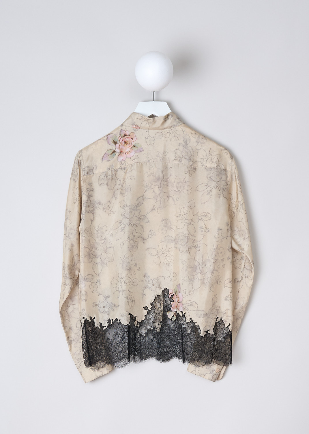 DRIES VAN NOTEN, SILK FLORAL BLOUSE WITH BLACK LACE DETAILING, Beige, Print, Black. Back, This long sleeve beige silk blouse has a muted floral print with pink accents. The black floral lace hem snakes up along the front. The blouse has a pointed collar and a front button closure. The long sleeves have buttoned cuffs. 
