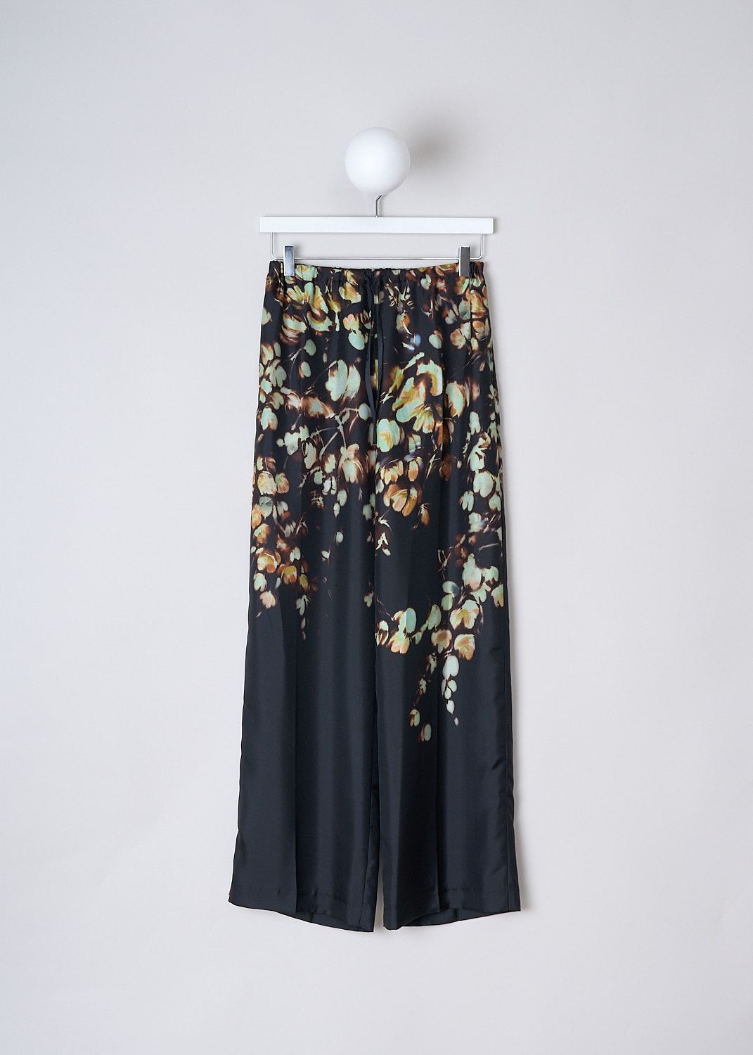 DRIES VAN NOTEN, SILK PUVIS PANTS WITH FLORAL PRINT, PUVIS_LONG_7275_WW_PANTS_PET, Black, Print, Orange, Front, These silk Puvis pants have a black base color with a bleached orange and green floral print. These slip-on pants have an elasticated waistband with drawstring. The loose pant legs have a straight hemline. 