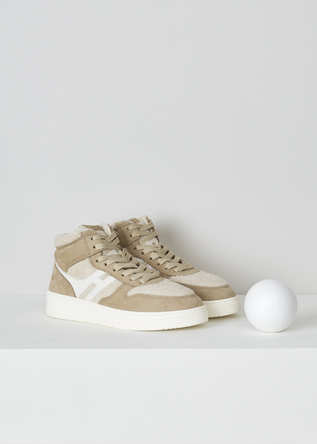 HOGAN, BEIGE TEDDY H630 BASKET SNEAKERS, GYW6300FE30SQW02S1_SQW, Beige, Front, These beige H630 Basket sneakers feature a front lace-up fastening with beige laces. On the tongue, a  brown leather tab has the brand's logo embossed on it. The sneaker consist of brown suede and white teddy fabric. On the side, the brand's H logo has been incorporated in the design in white leather.  These sneakers have a thick white sole. They come with an additional pair of laces in brown.   
