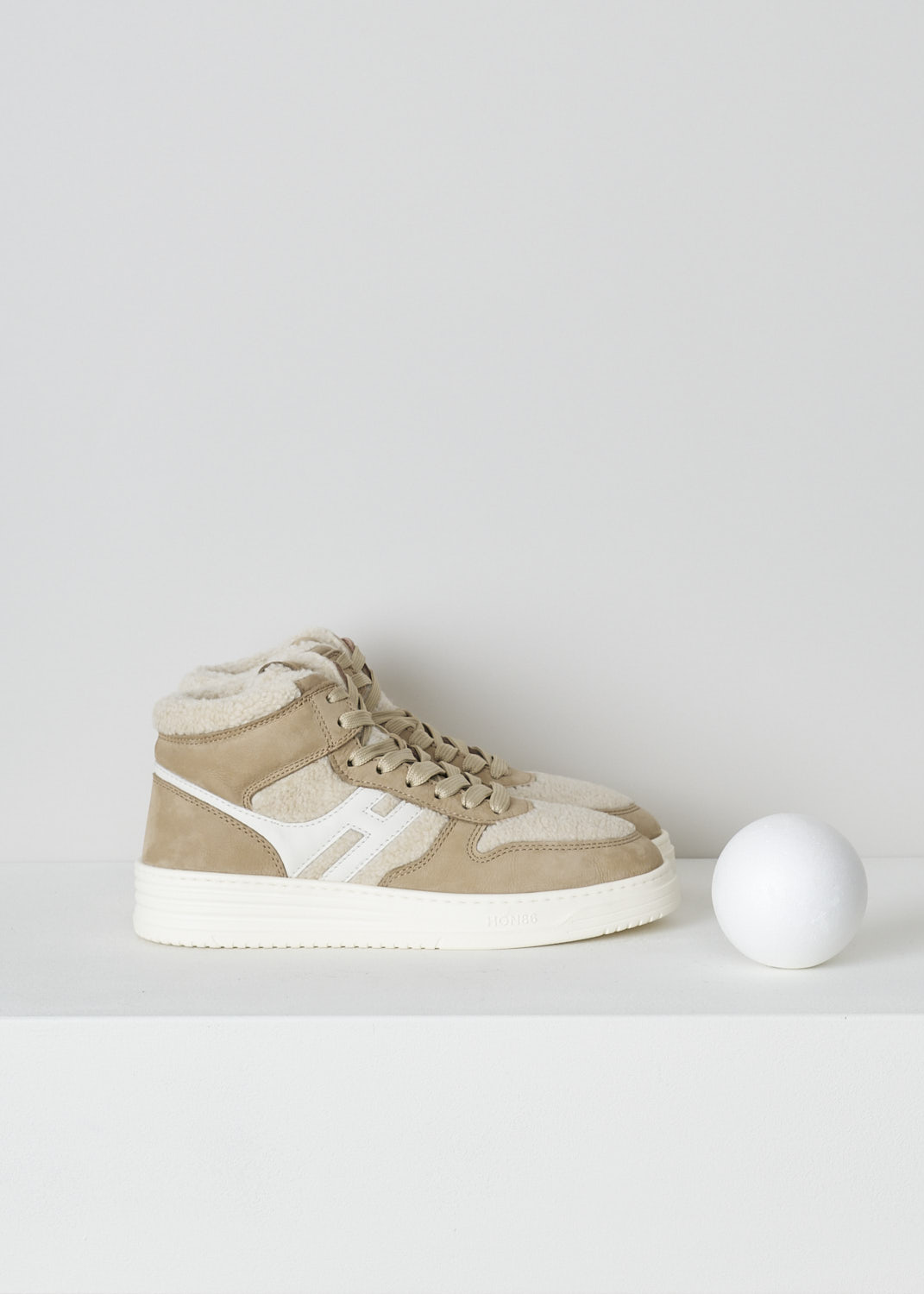 HOGAN, BEIGE TEDDY H630 BASKET SNEAKERS, GYW6300FE30SQW02S1_SQW, Beige, Side, These beige H630 Basket sneakers feature a front lace-up fastening with beige laces. On the tongue, a  brown leather tab has the brand's logo embossed on it. The sneaker consist of brown suede and white teddy fabric. On the side, the brand's H logo has been incorporated in the design in white leather.  These sneakers have a thick white sole. They come with an additional pair of laces in brown.   
